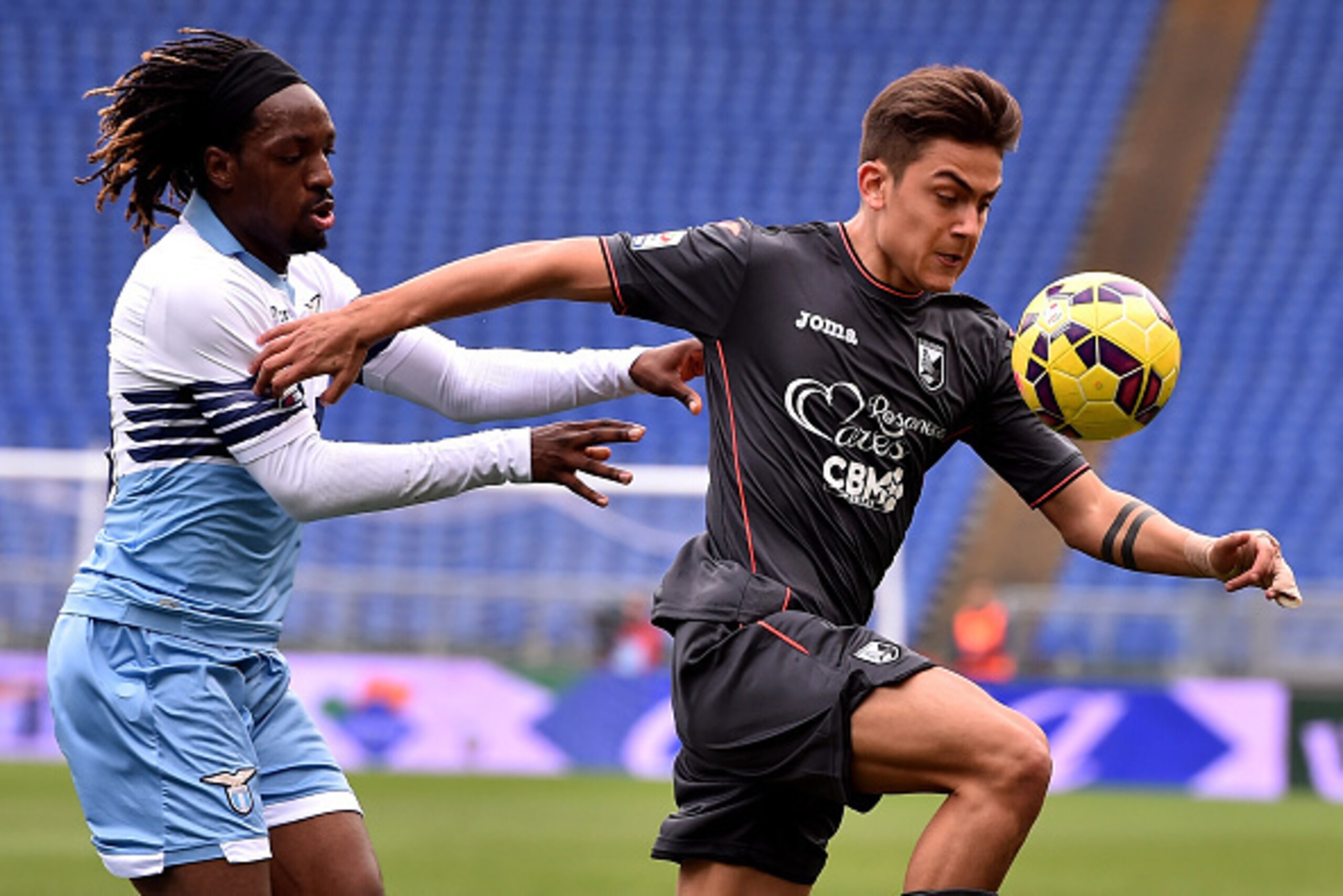 ROME, ITALY - FEBRUARY 22:  Paulo Dybala (R) of Palermo and Luis Pedro Cavanda of Lazio compete for the ball during the Serie A match between SS Lazio and US Citta di Palermo at Stadio Olimpico on February 22, 2015 in Rome, Italy.  (Photo by Tullio M. Pug