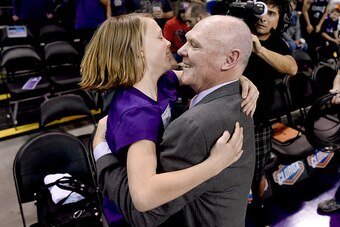 SACRAMENTO, CA - FEBRUARY 20: Head coach George Karl of the Sacramento Kings gets a hug from a young fan prior to the start of the game against the Boston Celtics at Sleep Train Arena on February 20, 2015 in Sacramento, California. NOTE TO USER: User expr