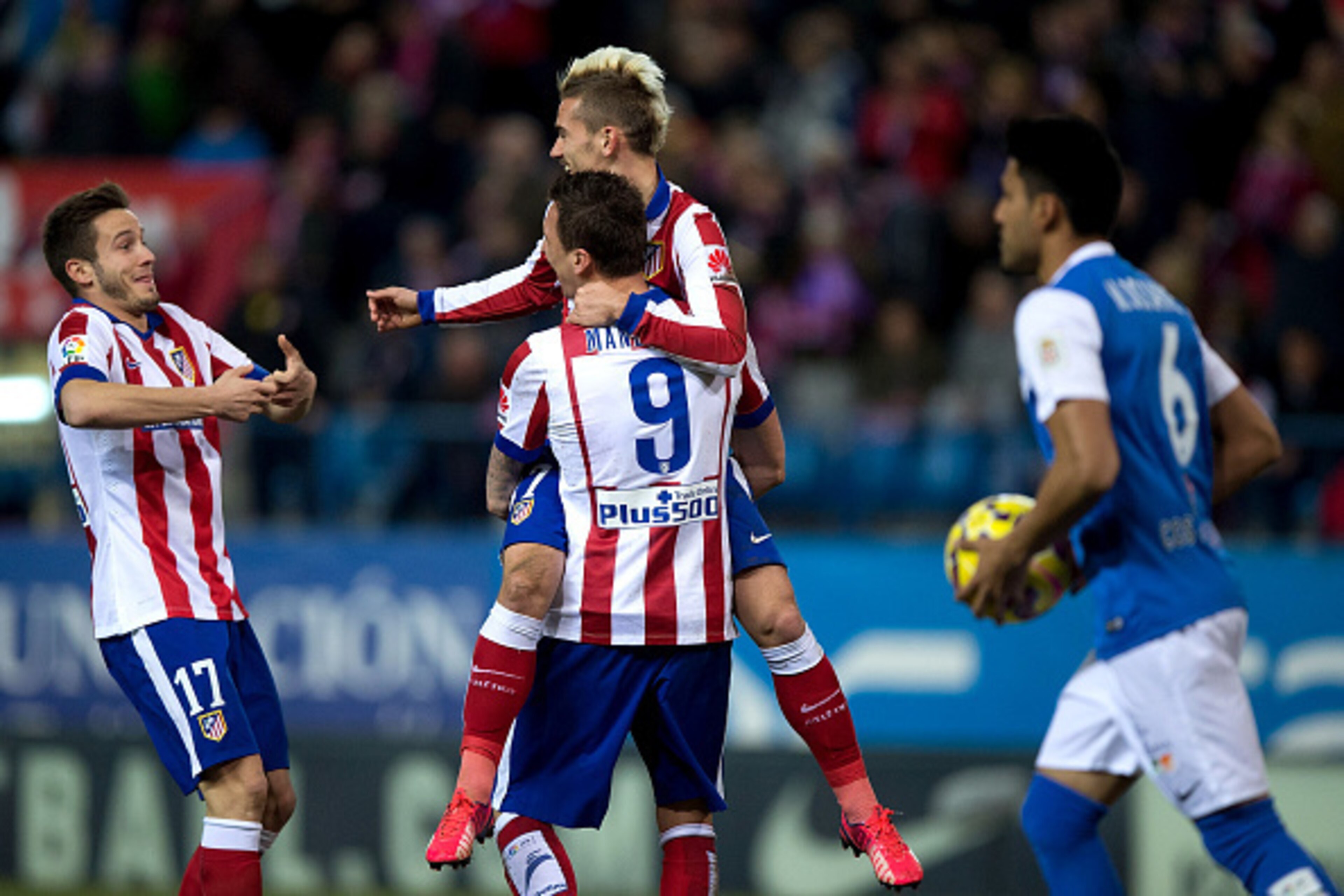 MADRID, SPAIN - FEBRUARY 21:  Antoine Griezmann (R) of Atletico de Madrid celebrates scoring their second goal with teammates Mario Mandzukic (2ndR) and Saul Niguez (L) during the La Liga match between Club Atletico de Madrid and UD Almeria at Vicente Cal