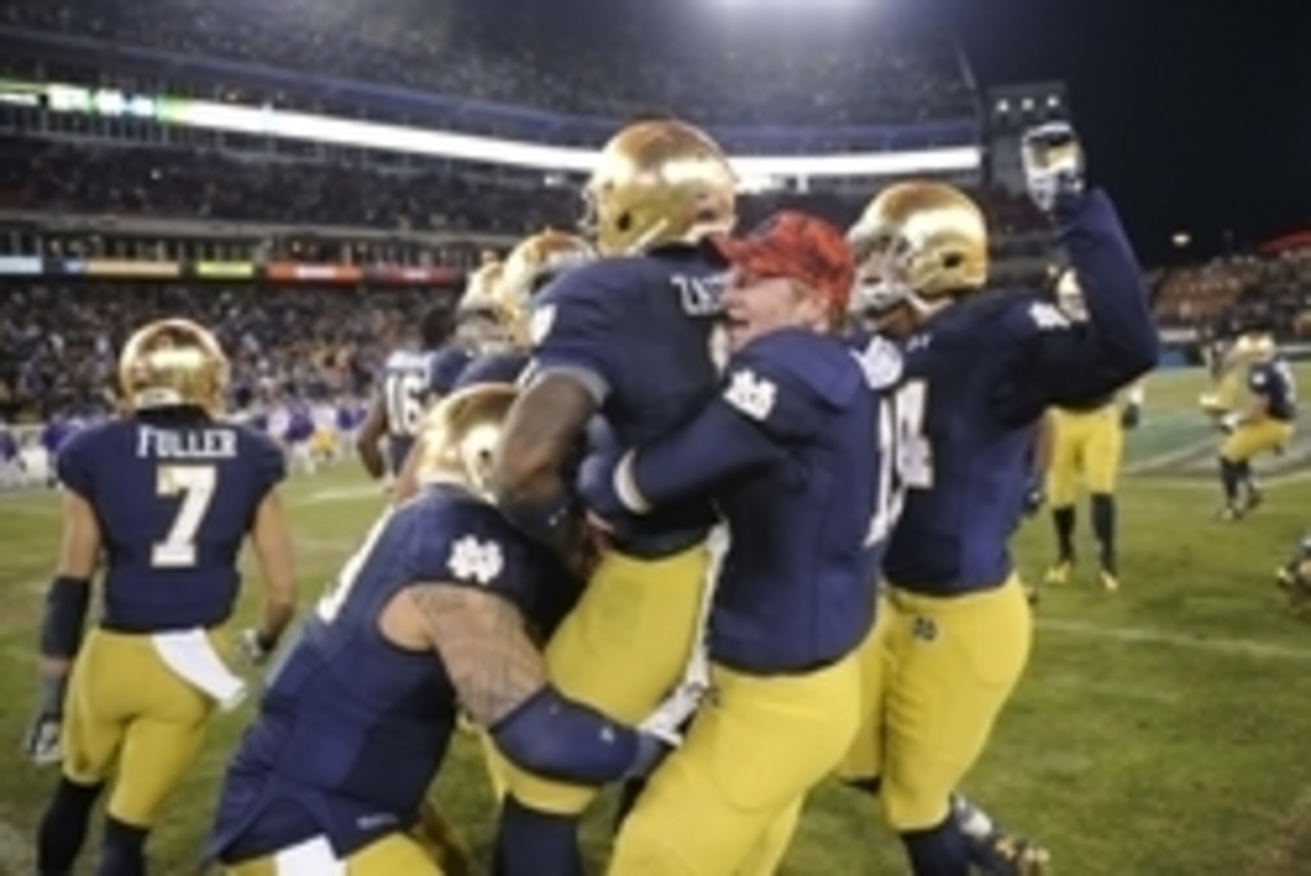 Dec 30, 2014; Nashville, TN, USA; Notre Dame Fighting Irish quarterback Malik Zaire (8) celebrates with teammates after winning against the LSU Tigers in the Music City Bowl at LP Field. Notre Dame won 31-28. Mandatory Credit: Christopher Hanewinckel-USA 
