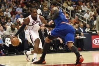 Nov 8, 2014; Atlanta, GA, USA; Atlanta Hawks forward Paul Millsap (4) is grabbed by New York Knicks forward Carmelo Anthony (7) during the second half at Philips Arena. The Hawks defeated the Knicks 103-96. Mandatory Credit: Dale Zanine-USA TODAY Sports