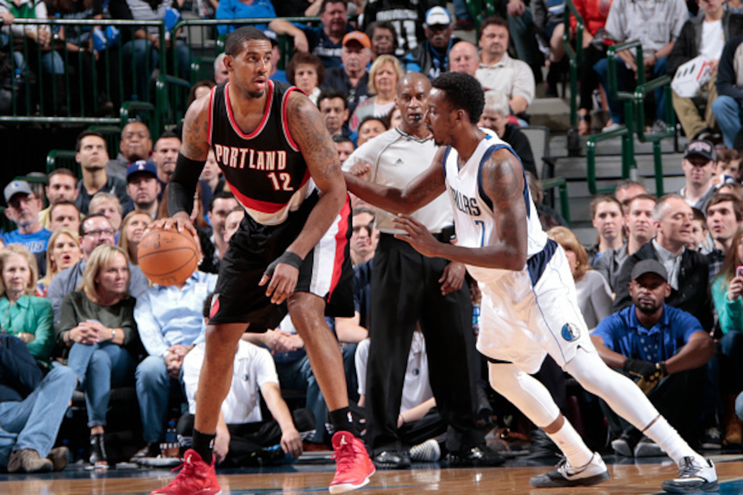 DALLAS, TX - FEBRUARY 7: LaMarcus Aldridge #12 of the Portland Trail Blazers handles the ball against Al-Farouq Aminu #7 of the Dallas Mavericks on February 7, 2015 at the American Airlines Center in Dallas, Texas. NOTE TO USER: User expressly acknowledge
