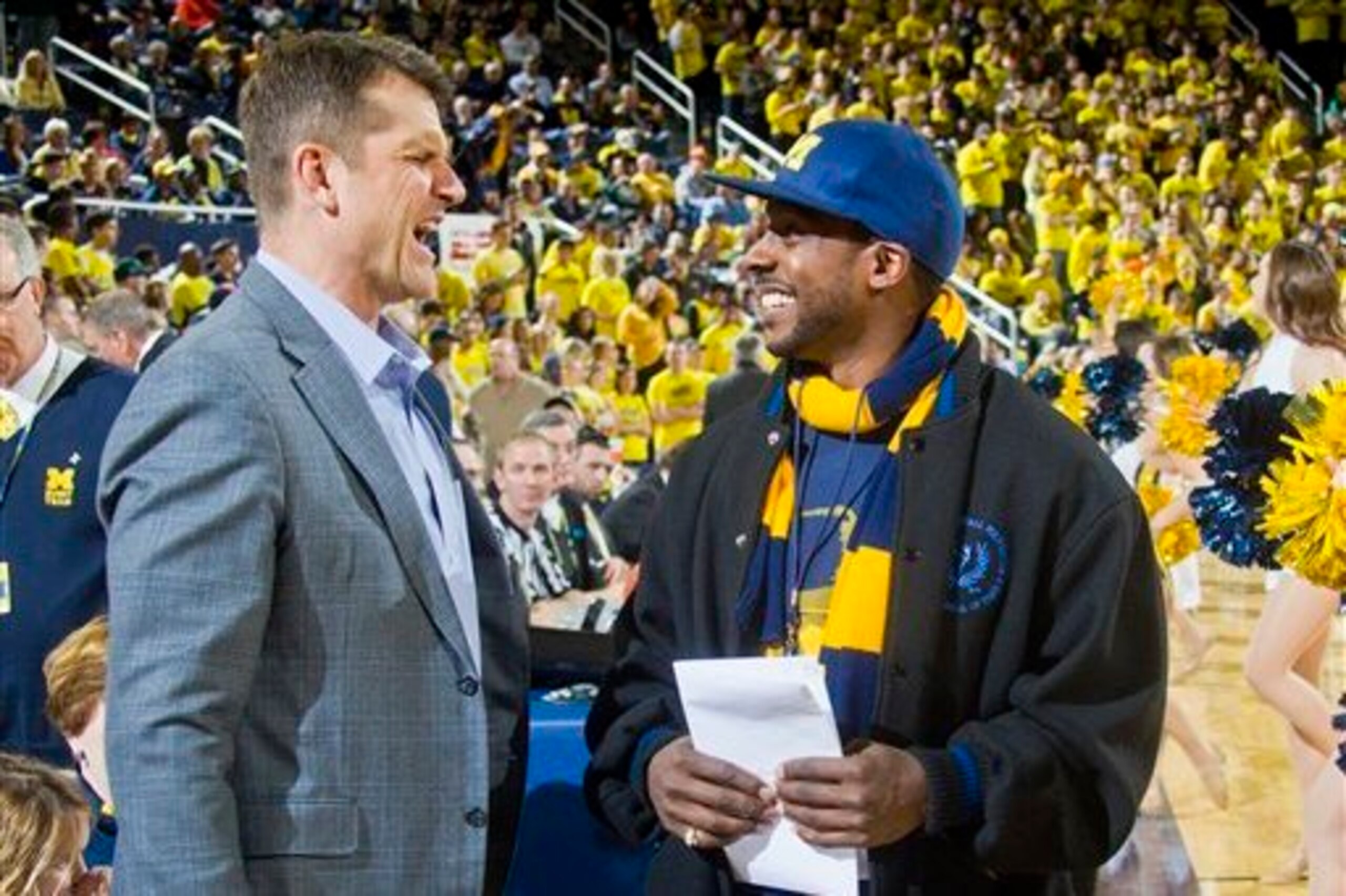 Jim Harbaugh chats with Michigan legend Desmond Howard.