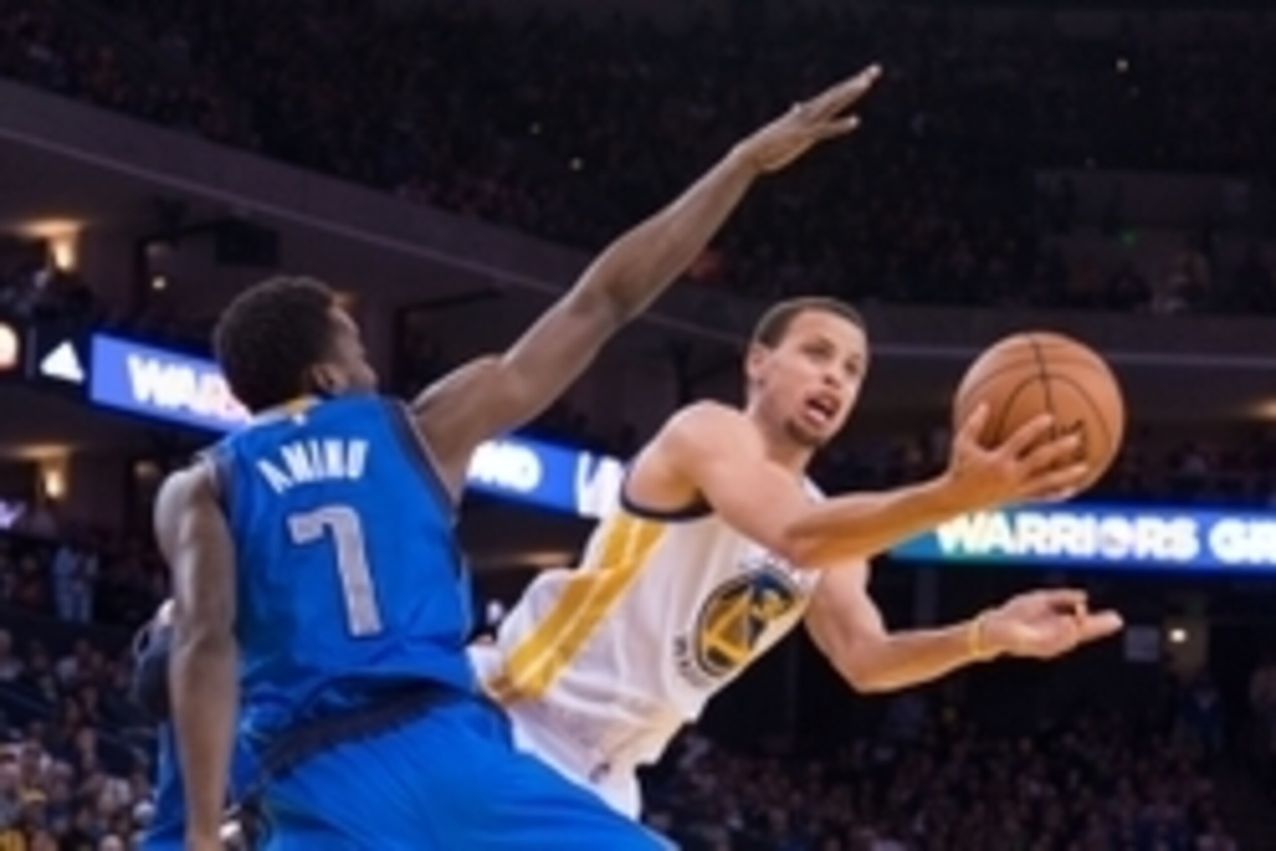 February 4, 2015; Oakland, CA, USA; Golden State Warriors guard Stephen Curry (30, right) shoots the basketball against Dallas Mavericks forward Al-Farouq Aminu (7) during the third quarter at Oracle Arena. The Warriors defeated the Mavericks 128-114. Man