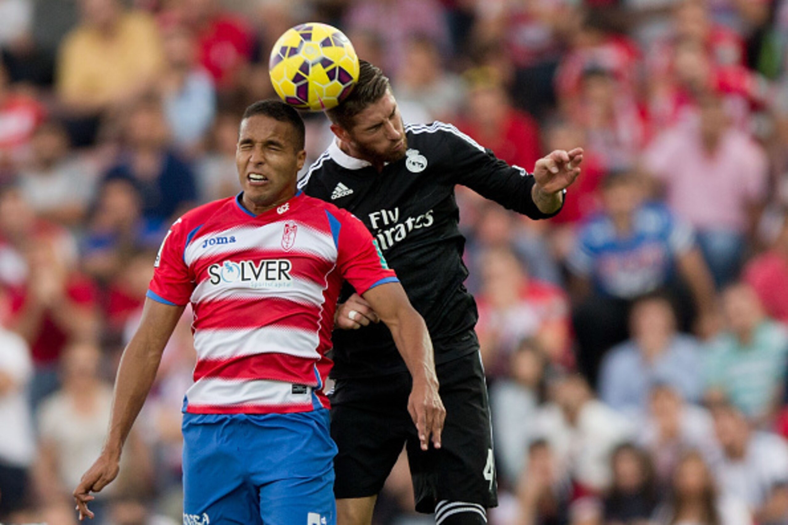 GRANADA, SPAIN - NOVEMBER 01: Sergio Ramos (R) of Real Madrid CF wins the header before Youssef El-Arabi of Granada CF during the La Liga match between Granada CF and Real Madrid CF at Nuevo Estadio de Los Carmenes on November 1, 2014 in Granada, Spain. GRANADA, SPAIN - NOVEMBER 01: Sergio Ramos (R) of Real Madrid CF wins the header before Youssef El-Arabi of Granada CF during the La Liga match between Granada CF and Real Madrid CF at Nuevo Estadio de Los Carmenes on November 1, 2014 in Granada, Spain.