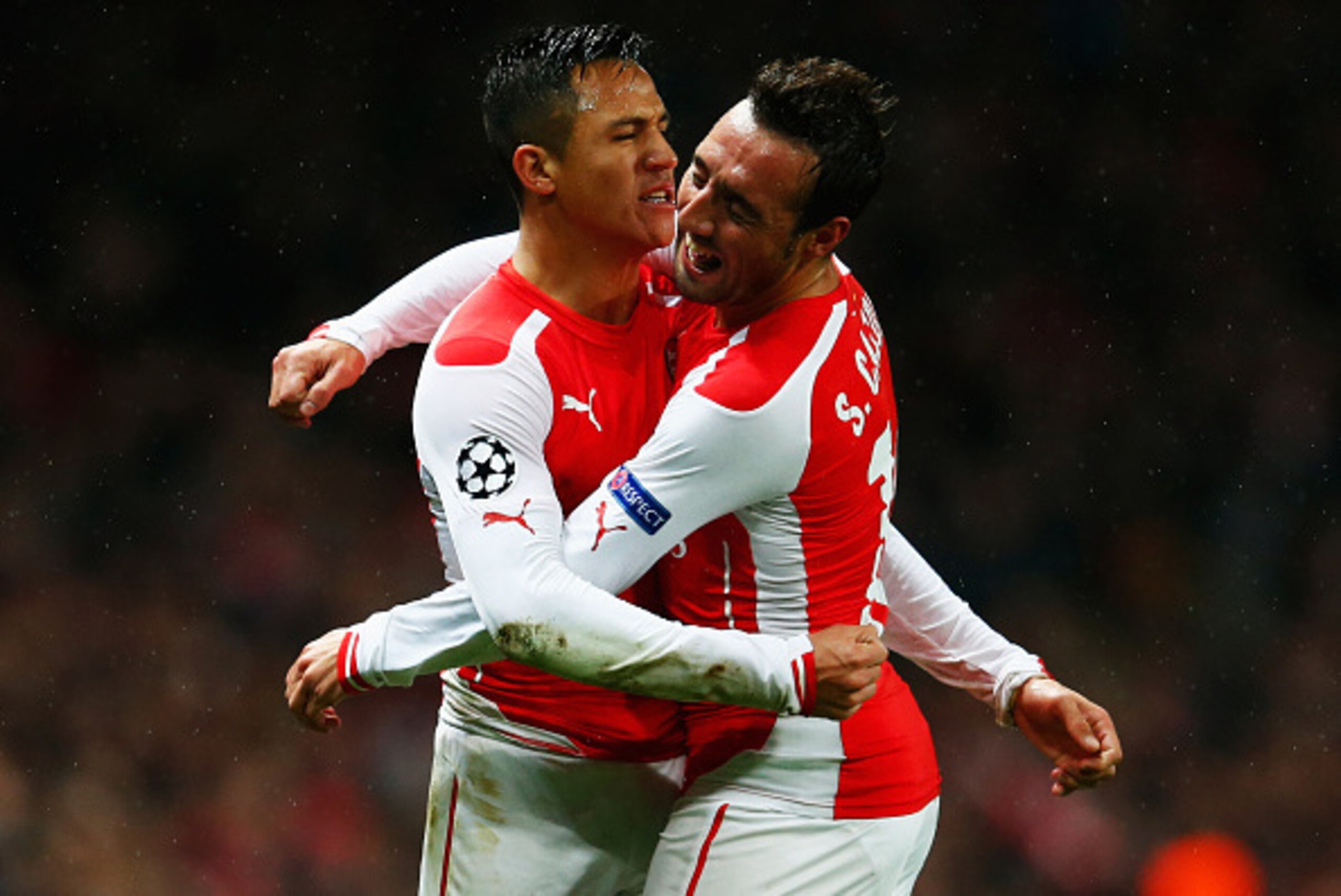 LONDON, ENGLAND - NOVEMBER 04:  Alexis Sanchez of Arsenal (L) celebrates with Santi Cazorla (R) as he scores their second goal during the UEFA Champions League Group D match between Arsenal FC and RSC Anderlecht at Emirates Stadium on November 4, 2014 in 