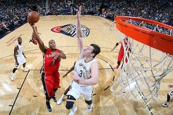 NEW ORLEANS, LA - FEBRUARY 23: Kyle Lowry #7 of the Toronto Raptors goes for the basket against Omer Asik #3 of the New Orleans Pelicans during the game on February 23, 2015 at Smoothie King Center in New Orleans, Louisiana. NOTE TO USER: User expressly a