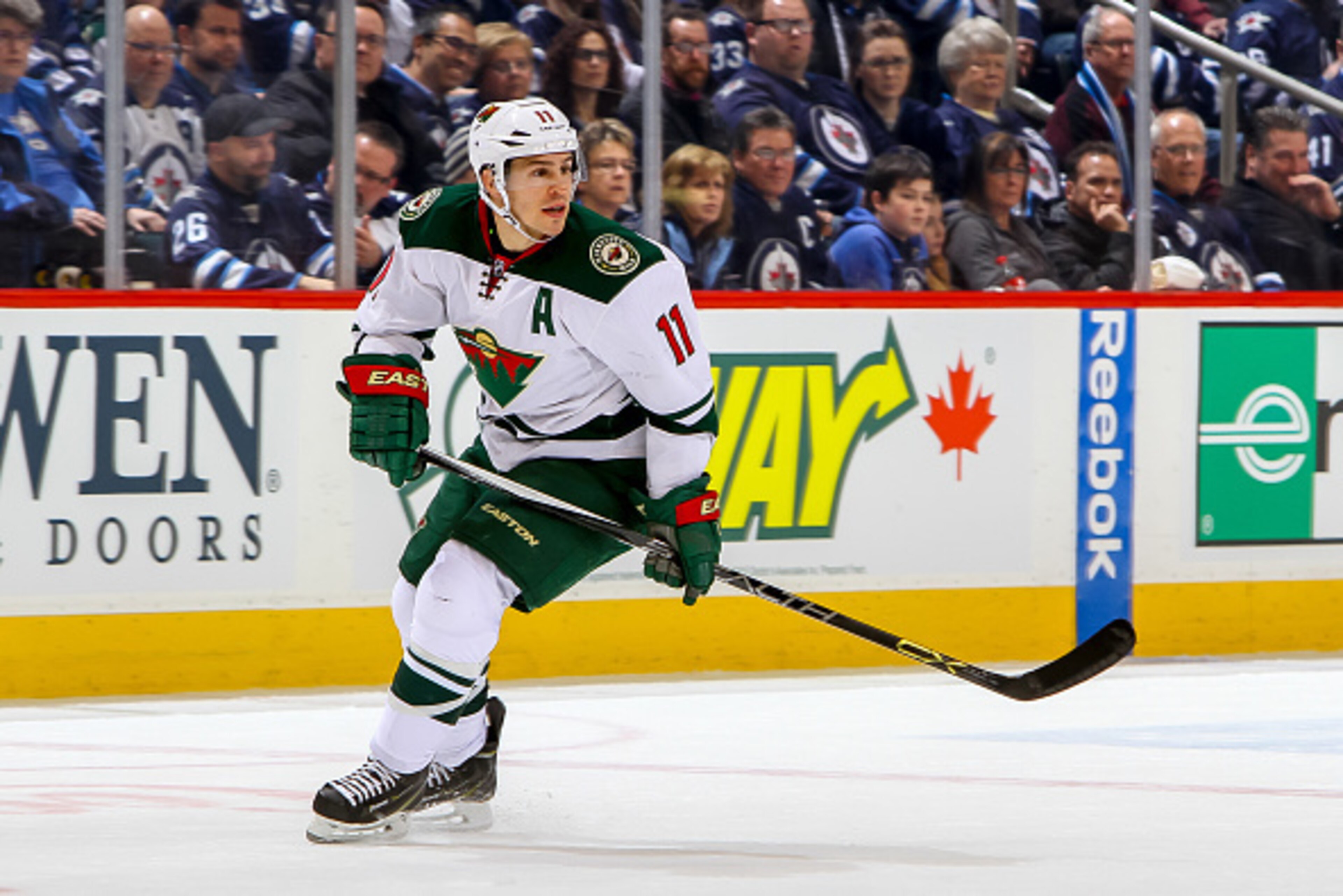 WINNIPEG, CANADA - FEBRUARY 10: Zach Parise #11 of the Minnesota Wild keeps an eye on the play during first period action against the Winnipeg Jets on February 10, 2015 at the MTS Centre in Winnipeg, Manitoba, Canada. The Jets defeated the Wild 2-1 in ove