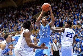 DURHAM, NC - FEBRUARY 18:  Isaiah Hicks #22 of the North Carolina Tar Heels drives between Justise Winslow #12 and Amile Jefferson #21 of the Duke Blue Devils during their game at Cameron Indoor Stadium on February 18, 2015 in Durham, North Carolina. Duke