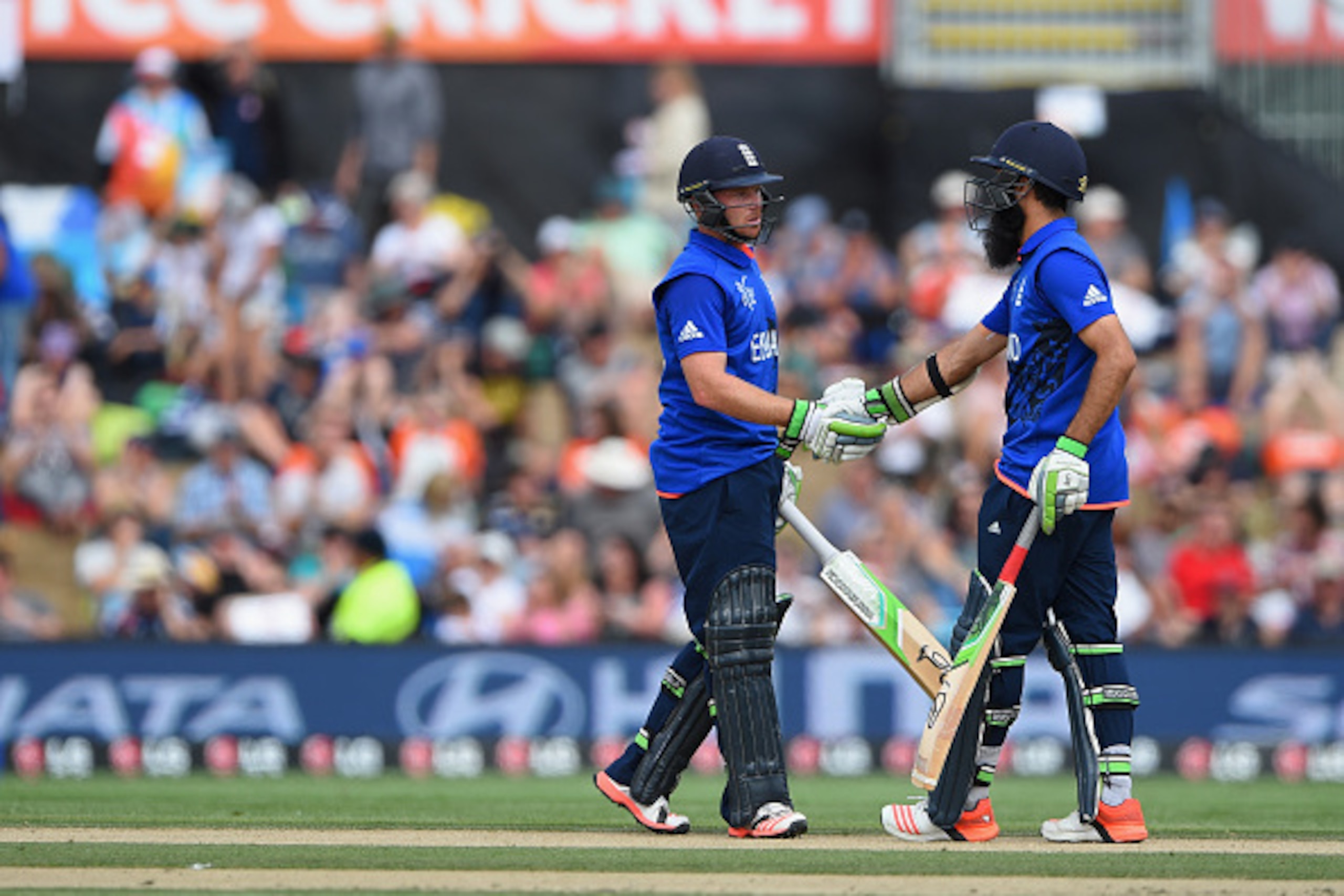 CHRISTCHURCH, NEW ZEALAND - FEBRUARY 23:  Ian Bell and Moeen Ali of England reach their 50 partnership during the 2015 ICC Cricket World Cup match between England and Scotland at Hagley Oval on February 23, 2015 in Christchurch, New Zealand.  (Photo by Sh