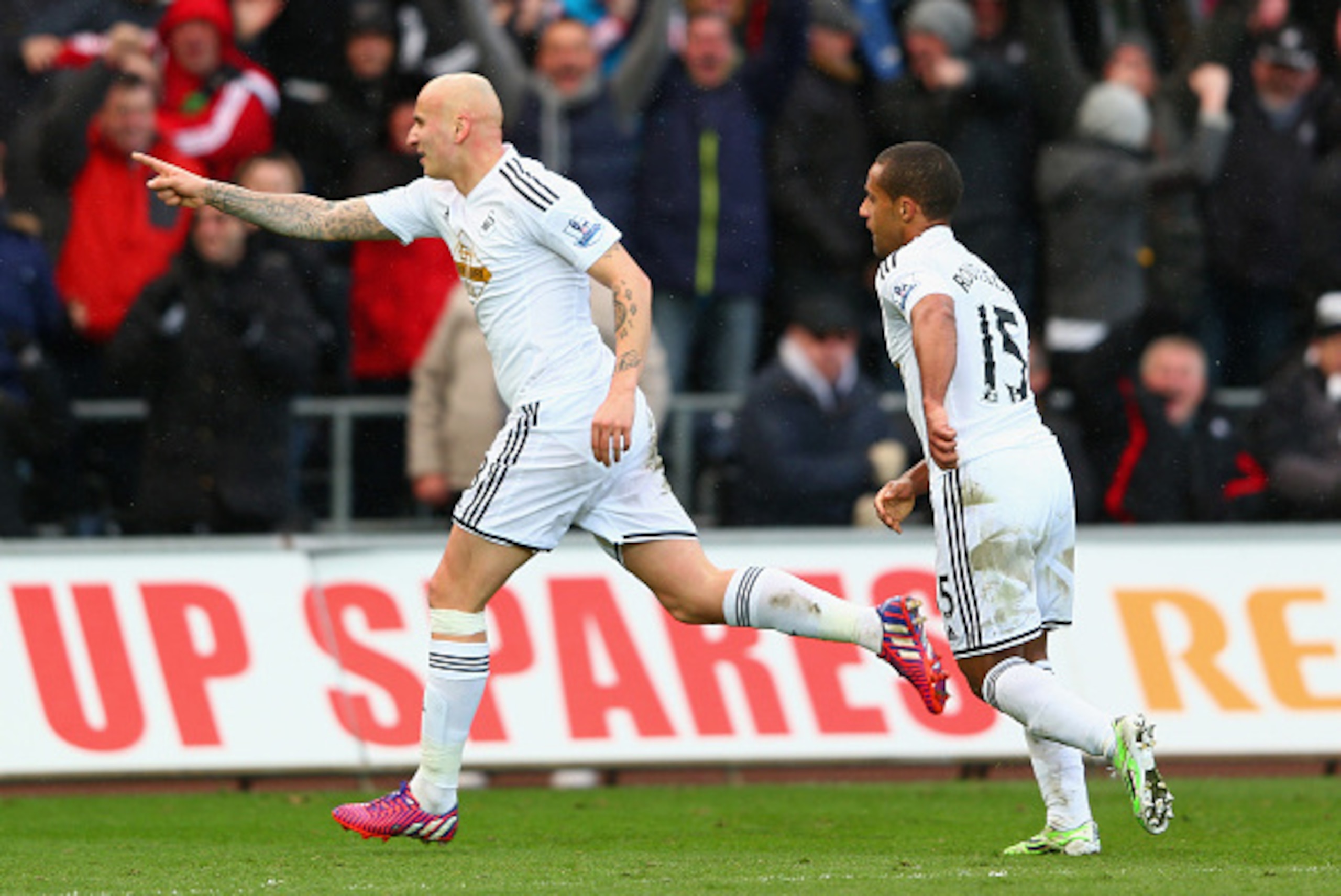 SWANSEA, WALES - FEBRUARY 21: Jonjo Shelvey of Swansea City celebrates scoring their second goal with Wayne Routledge of Swansea City during the Barclays Premier League match between Swansea City and Manchester United at Liberty Stadium on February 21, 20
