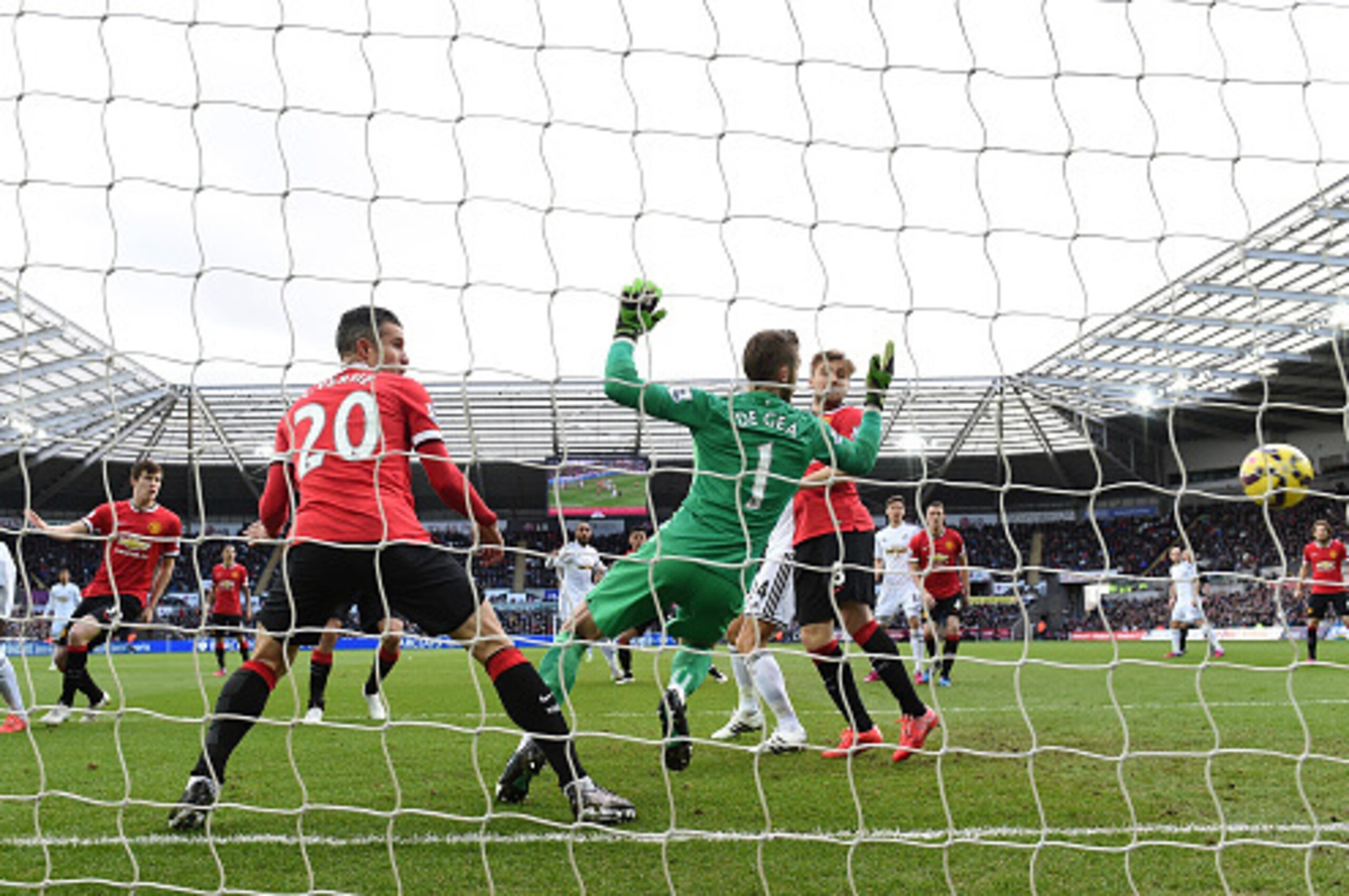 SWANSEA, WALES - FEBRUARY 21: Bafetimbi Gomis of Swansea (l) heads wide of the goal during the Barclays Premier League match between Swansea City and Manchester United at Liberty Stadium on February 21, 2015 in Swansea, Wales.  (Photo by Stu Forster/Getty