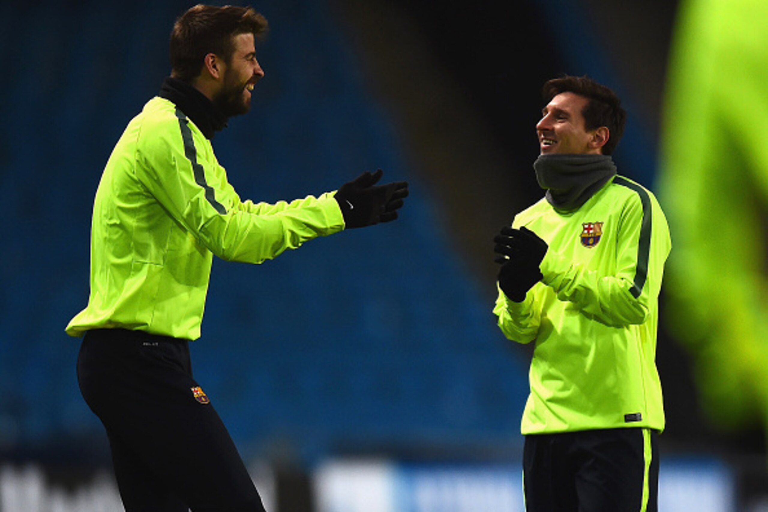 MANCHESTER, ENGLAND - FEBRUARY 23:  Gerard Pique (L) shares a joke with Lionel Messi of Barcelona during a Barcelona training session ahead of the UEFA Champions League round of 16 first leg match against Manchester City at Etihad Stadium on February 23, 