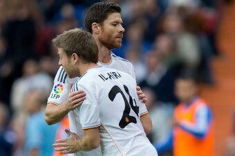 MADRID, SPAIN - NOVEMBER 09: Asier Illarramendi (R) of Real Madrid CF relevates his teammate Xabi Alonso (L) during the La Liga match between Real Madrid CF and Real Sociedad de Futbol  at Estadio Santiago Bernabeu on November 9, 2013 in Madrid, Spain.  (