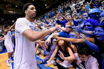 DURHAM, NC - FEBRUARY 18:  Jahlil Okafor #15 of the Duke Blue Devils celebrates with fans after a win against the North Carolina Tar Heels at Cameron Indoor Stadium on February 18, 2015 in Durham, North Carolina. Duke won 92-90 in overtime.  (Photo by Gra