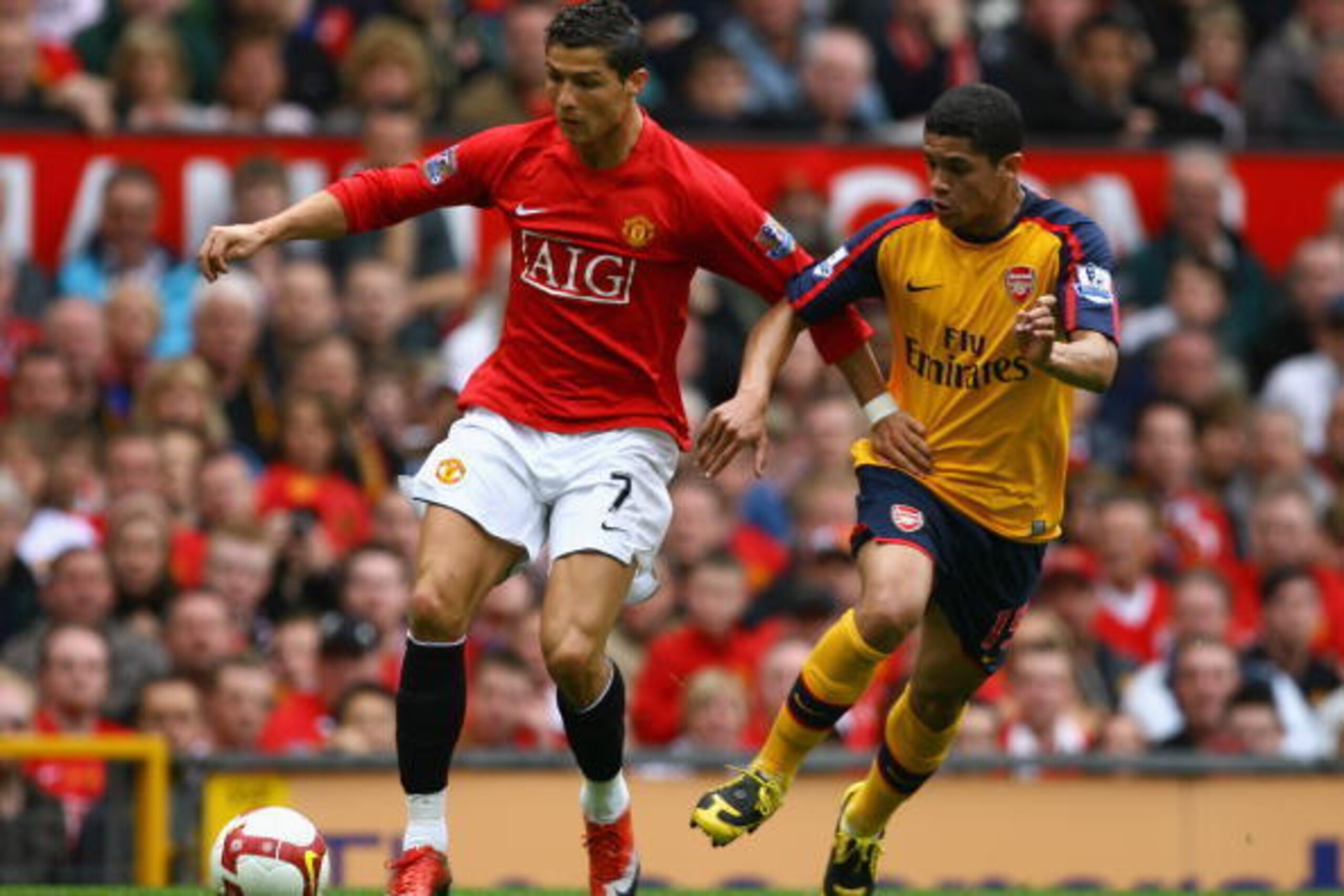 MANCHESTER, UNITED KINGDOM - MAY 16:   Cristiano Ronaldo of Manchester United holds off the challenge of Denilson of Arsenal  during the Barclays Premier League match between Manchester United and Arsenal at Old Trafford on May 16, 2009 in Manchester, Eng