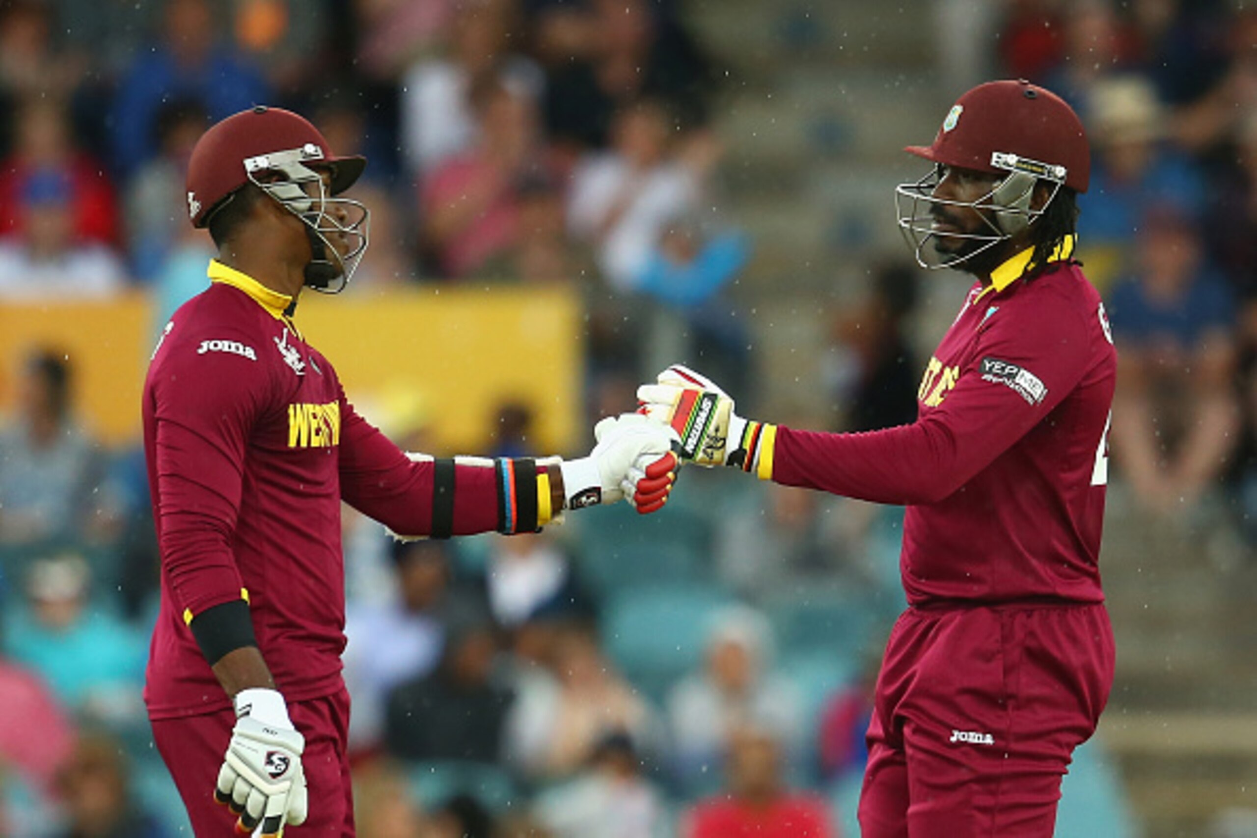 CANBERRA, AUSTRALIA - FEBRUARY 24: Marlon Samuels and Chris Gayle of West Indies fist bump as they bat during their partnership of 372 during the 2015 ICC Cricket World Cup match between the West Indies and Zimbabwe at Manuka Oval on February 24, 2015 in CANBERRA, AUSTRALIA - FEBRUARY 24: Marlon Samuels and Chris Gayle of West Indies fist bump as they bat during their partnership of 372 during the 2015 ICC Cricket World Cup match between the West Indies and Zimbabwe at Manuka Oval on February 24, 2015 in