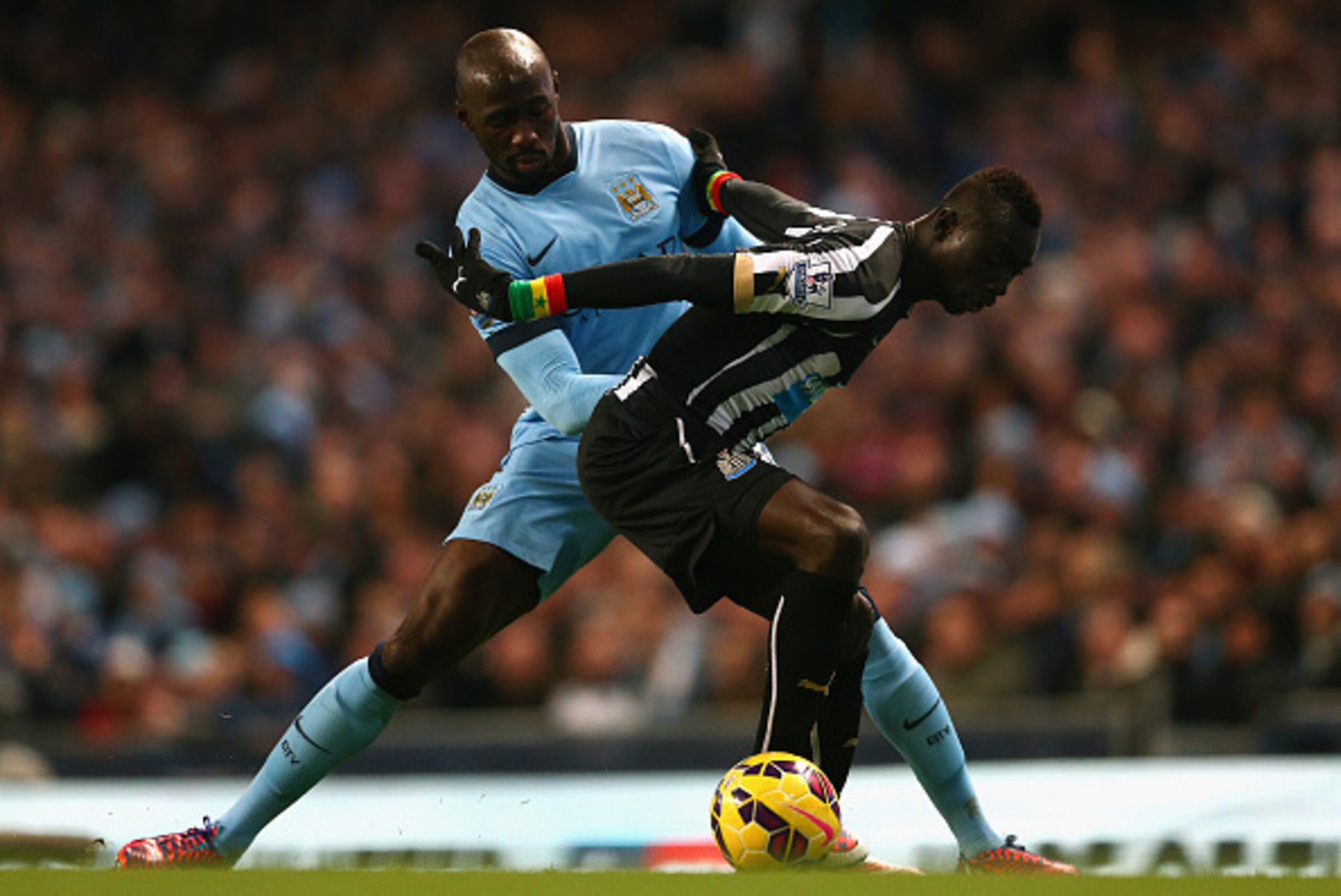 MANCHESTER, ENGLAND - FEBRUARY 21:  Eliaquim Mangala of Manchester City and Papiss Demba Cisse of Newcastle United battle for the ball during the Barclays Premier League match between Manchester City and Newcastle United at Etihad Stadium on February 21, 