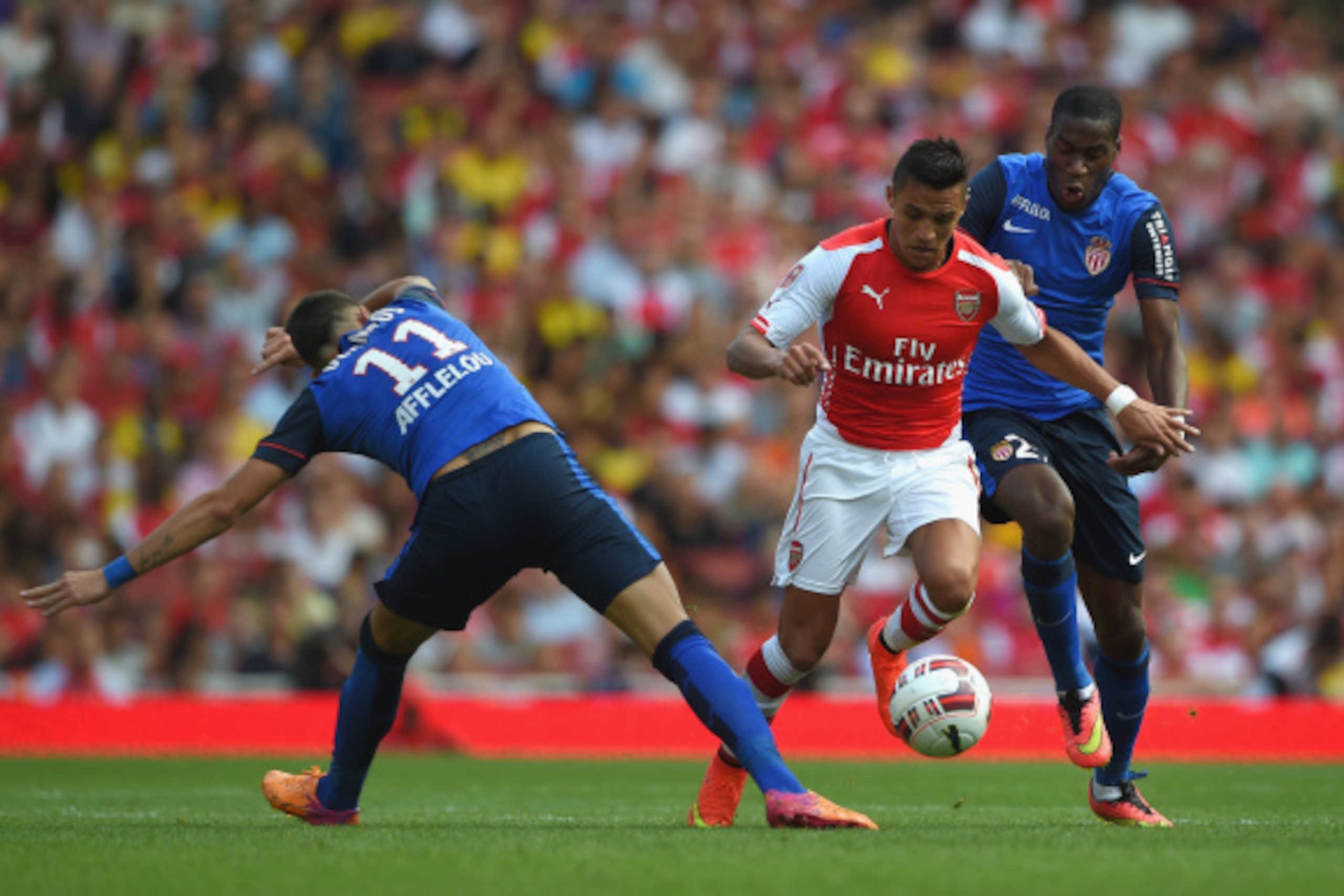 LONDON, ENGLAND - AUGUST 03:  Alexis Sanchez of Arsenal in action with Geoffrey Kondogbia and Lucas Ocampos of Monaco during the Emirates Cup match between Arsenal and AS Monaco at the Emirates Stadium on August 3, 2014 in London, England.  (Photo by Mich
