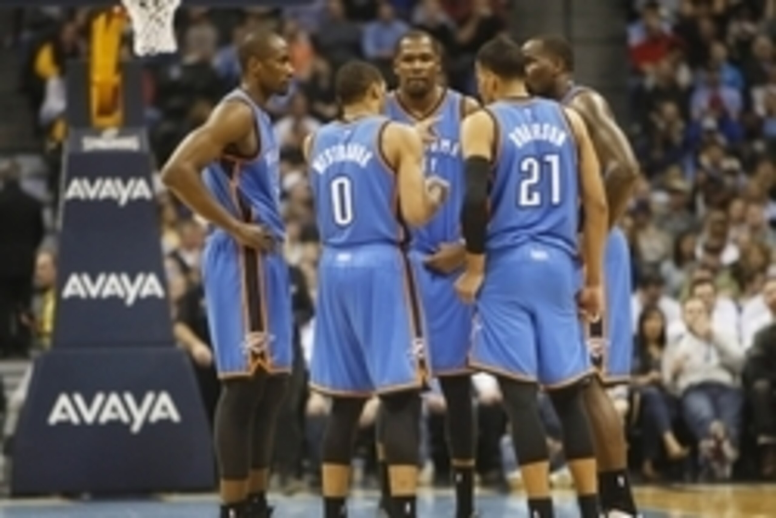 Feb 9, 2015; Denver, CO, USA; Oklahoma City Thunder guard Russell Westbrook (0), forward Kevin Durant (35), guard Andre Roberson (21), and forward Serge Ibaka (far right) huddle during the second half against the Denver Nuggets at Pepsi Center. The Thunde