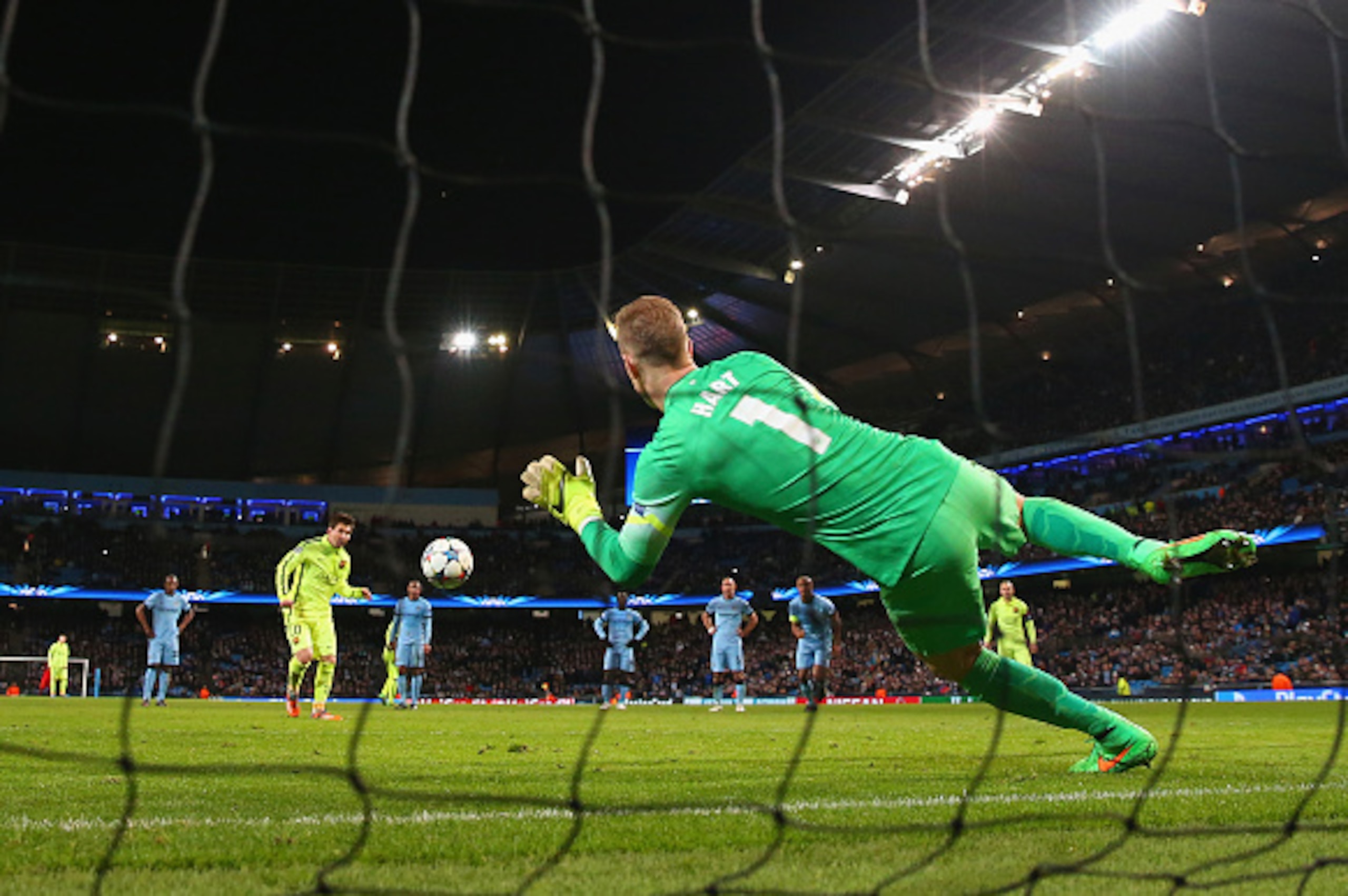 MANCHESTER, ENGLAND - FEBRUARY 24: Joe Hart of Manchester City saves a penalty from Lionel Messi of Barcelona during the UEFA Champions League Round of 16 match between Manchester City and Barcelona at Etihad Stadium on February 24, 2015 in Manchester, Un
