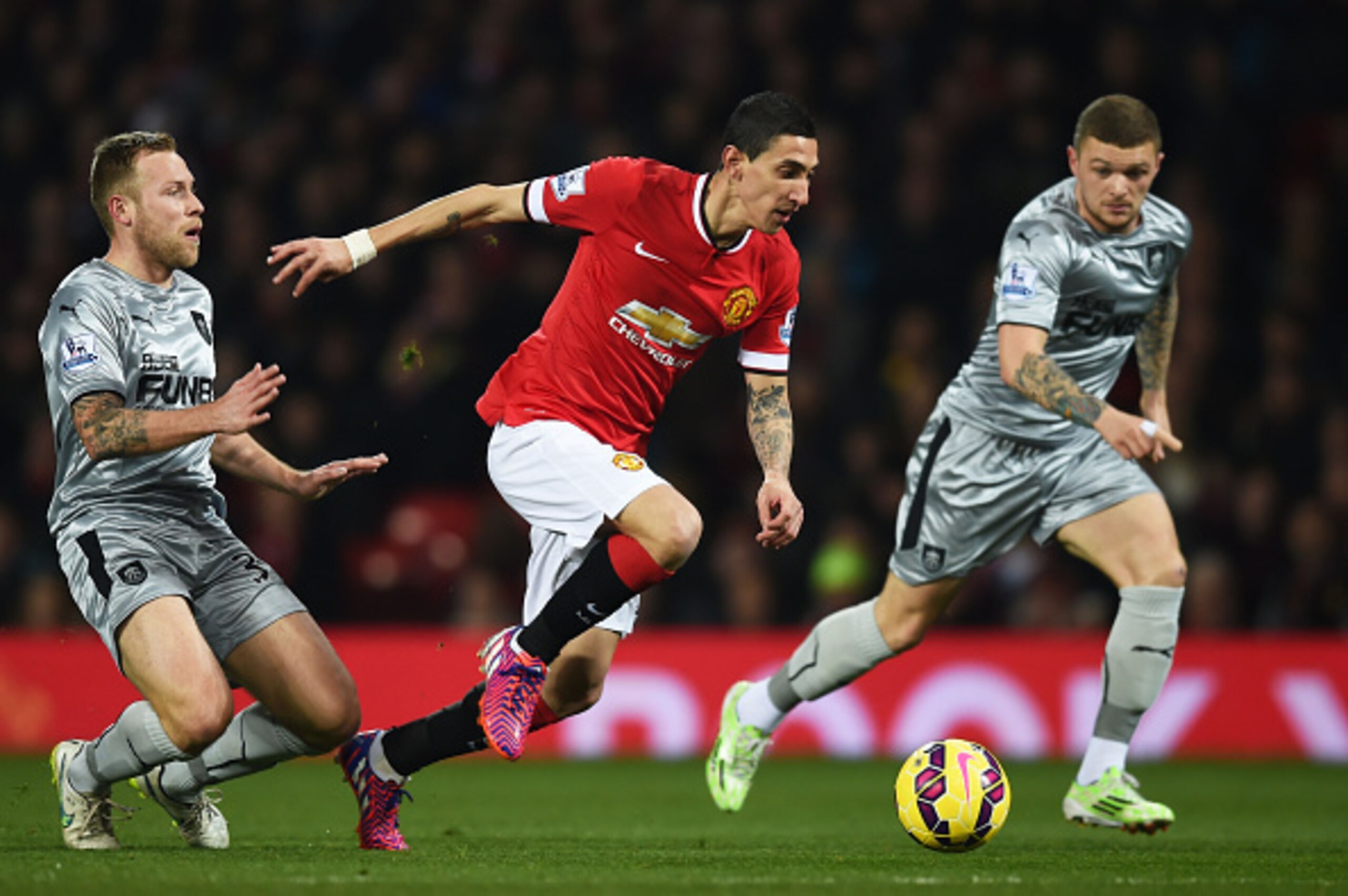 MANCHESTER, ENGLAND - FEBRUARY 11: Angel Di Maria of Manchester United skips away from Scott Arfield of Burnley during the Barclays Premier League match between Manchester United and Burnley at Old Trafford on February 11, 2015 in Manchester, England.  (P