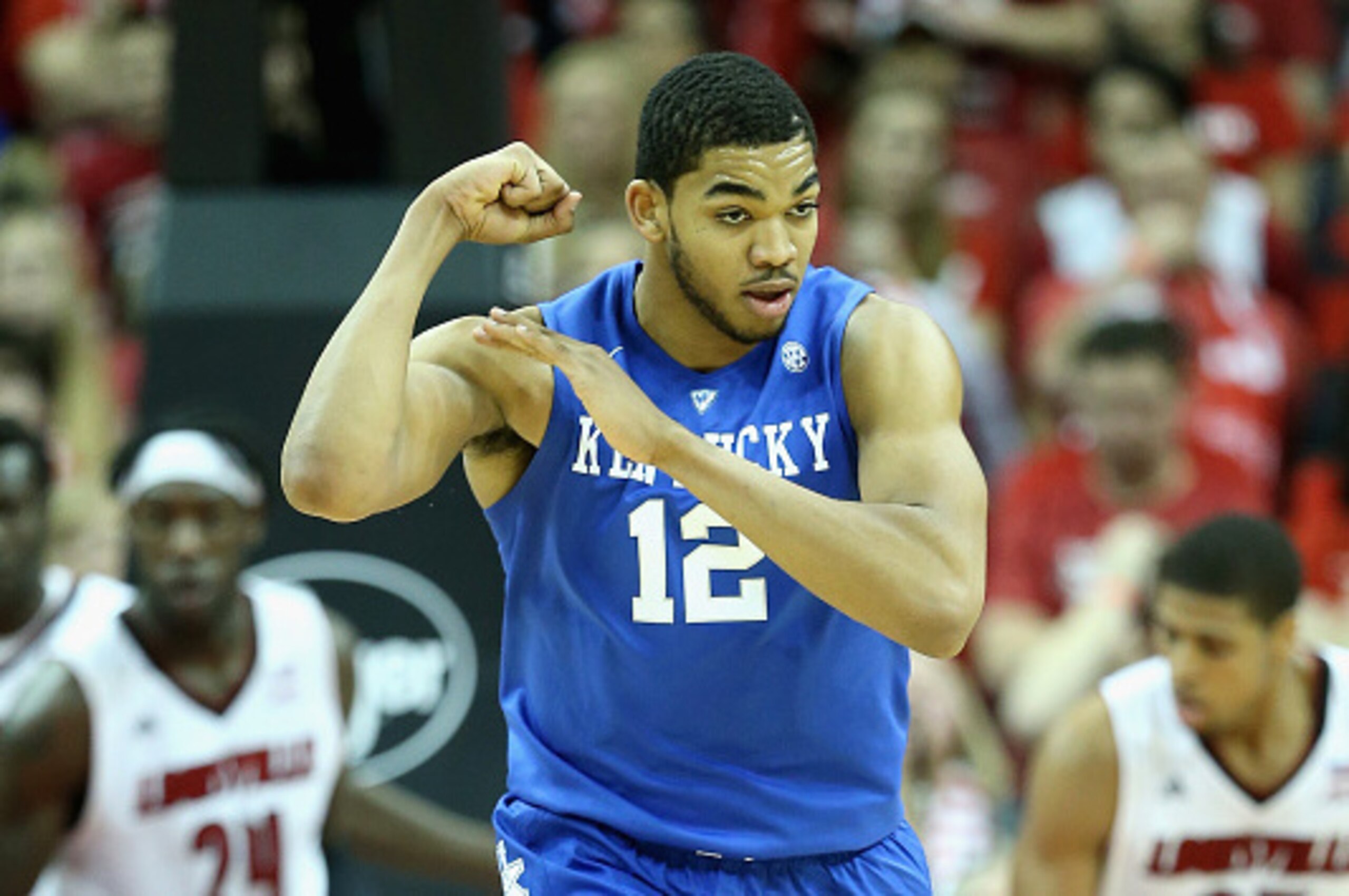 LOUISVILLE, KY - DECEMBER 27:  Karl-Anthony Towns #12  of the Kentucky Wildcats celebrates by flexing his muscles during the game against the Louisville Cardinals at KFC YUM! Center on December 27, 2014 in Louisville, Kentucky.  Kentucky won 58-50.  (Phot
