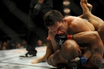 May 24, 2014; Las Vegas, NV, USA; Robbie Lawler (red) is pinned down by Jake Ellenberger (blue) during their UFC 173 light heavyweight bout at MGM Grand Garden Arena. Lawler won his bout by way of TKO. Mandatory Credit: Stephen R. Sylvanie-USA TODAY Sport