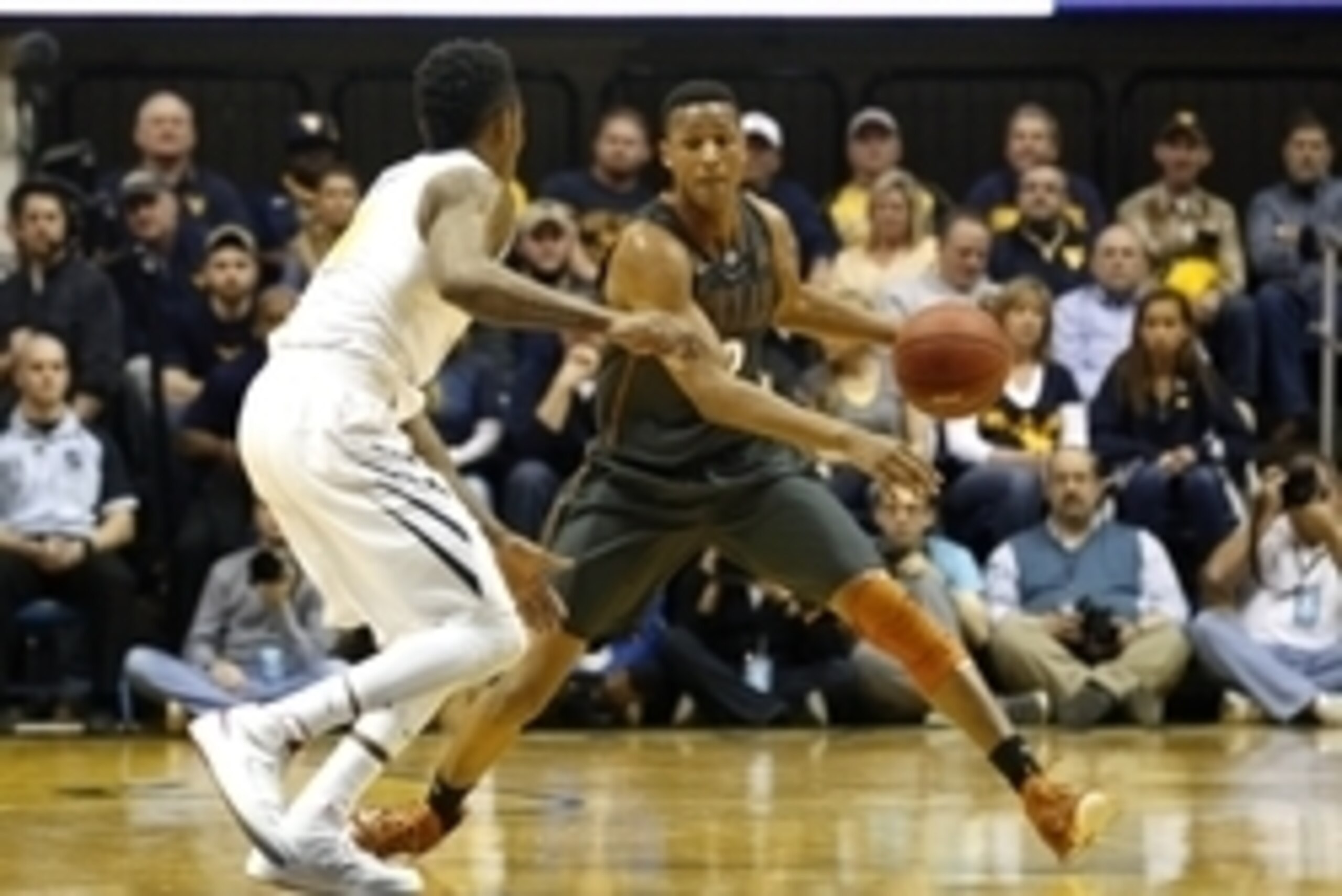 Feb 24, 2015; Morgantown, WV, USA; Texas Longhorns guard Demarcus Holland (2) controls the ball  during the first half against the West Virginia Mountaineers at WVU Coliseum. Mandatory Credit: Aaron Doster-USA TODAY Sports