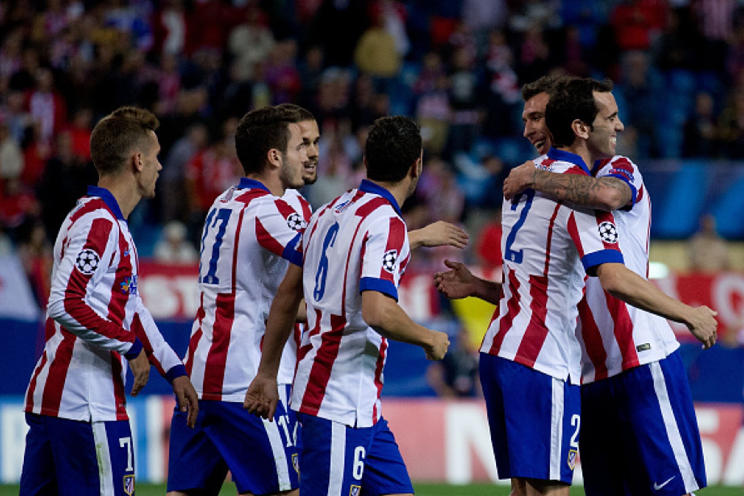 MADRID, SPAIN - OCTOBER 22: Mario Mandzukic (R) of Atletico de Madrid embraces his teammate Diego Godin (2ndR) celebrating scoring their second goal and surrounded by teammates as Antoine Griezmann (L), Saul Niguez (2ndL), Mario Suarez (3dL) and Koke (3d MADRID, SPAIN - OCTOBER 22: Mario Mandzukic (R) of Atletico de Madrid embraces his teammate Diego Godin (2ndR) celebrating scoring their second goal and surrounded by teammates as Antoine Griezmann (L), Saul Niguez (2ndL), Mario Suarez (3dL) and Koke (3d