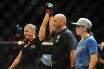 Jul 5, 2014; Las Vegas, NV, USA; Ronda Rousey (red gloves) celebrates her victory over Alexis Davis during the first round of their bantamweight fight at Mandalay Bay Events Center. Mandatory Credit: Stephen R. Sylvanie-USA TODAY Sports