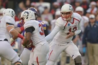 Dec 20, 2014; Kansas City, MO, USA; Colorado State Pueblo Thunderwolves quarterback Chris Bonner (12) hands off to Colorado State Pueblo Thunderwolves running back Cameron McDondle (30) during the first half at Sporting Park. Mandatory Credit: Denny Medle
