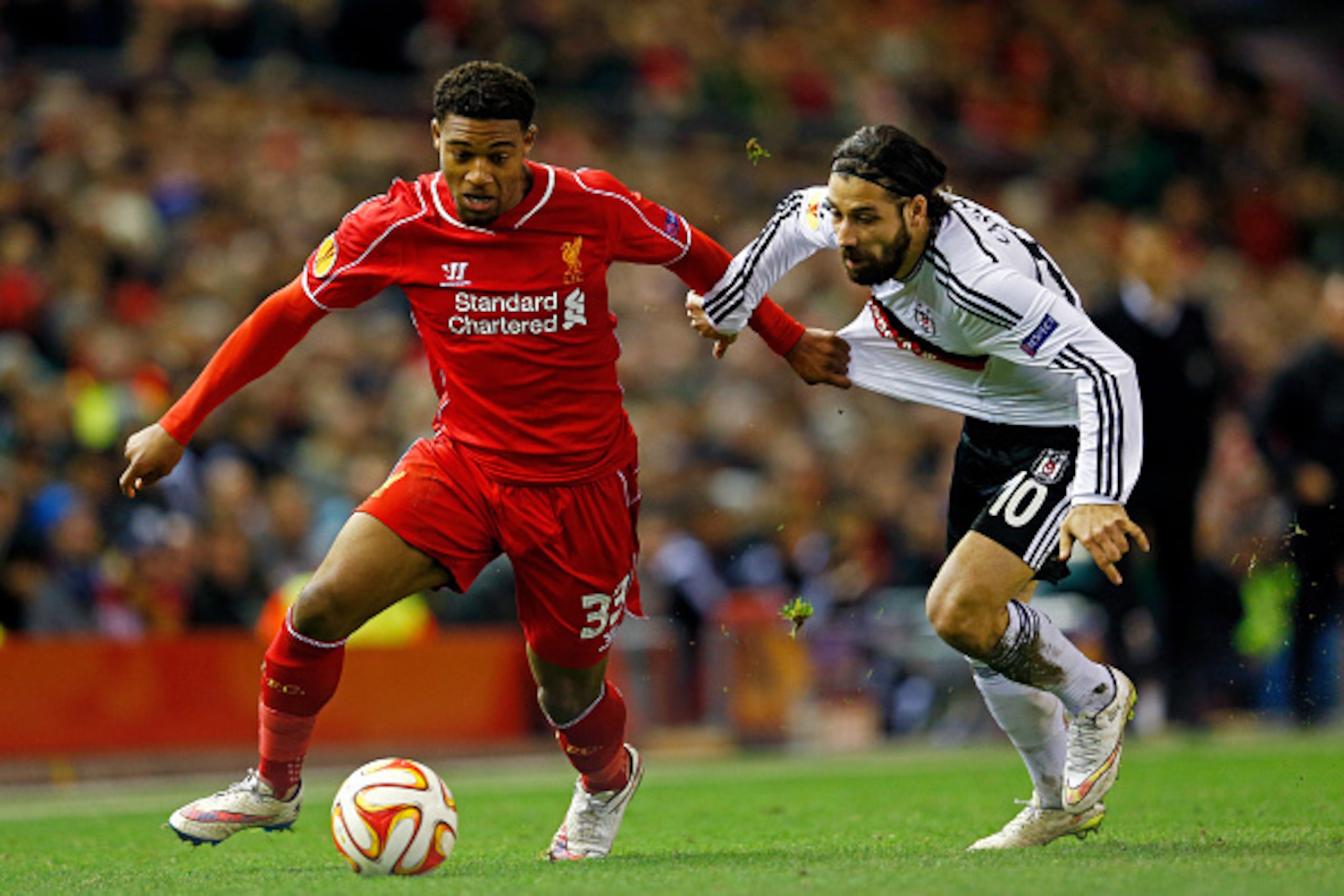 LIVERPOOL, ENGLAND - FEBRUARY 19: Jordon Ibe of Liverpool goes past Olcay Sahan of Besiktas during the UEFA Europa League Round of 32 match between Liverpool FC and Besiktas JK at Anfield on February 19, 2015 in Liverpool, United Kingdom. (Photo by Juli LIVERPOOL, ENGLAND - FEBRUARY 19: Jordon Ibe of Liverpool goes past Olcay Sahan of Besiktas during the UEFA Europa League Round of 32 match between Liverpool FC and Besiktas JK at Anfield on February 19, 2015 in Liverpool, United Kingdom. (Photo by Juli