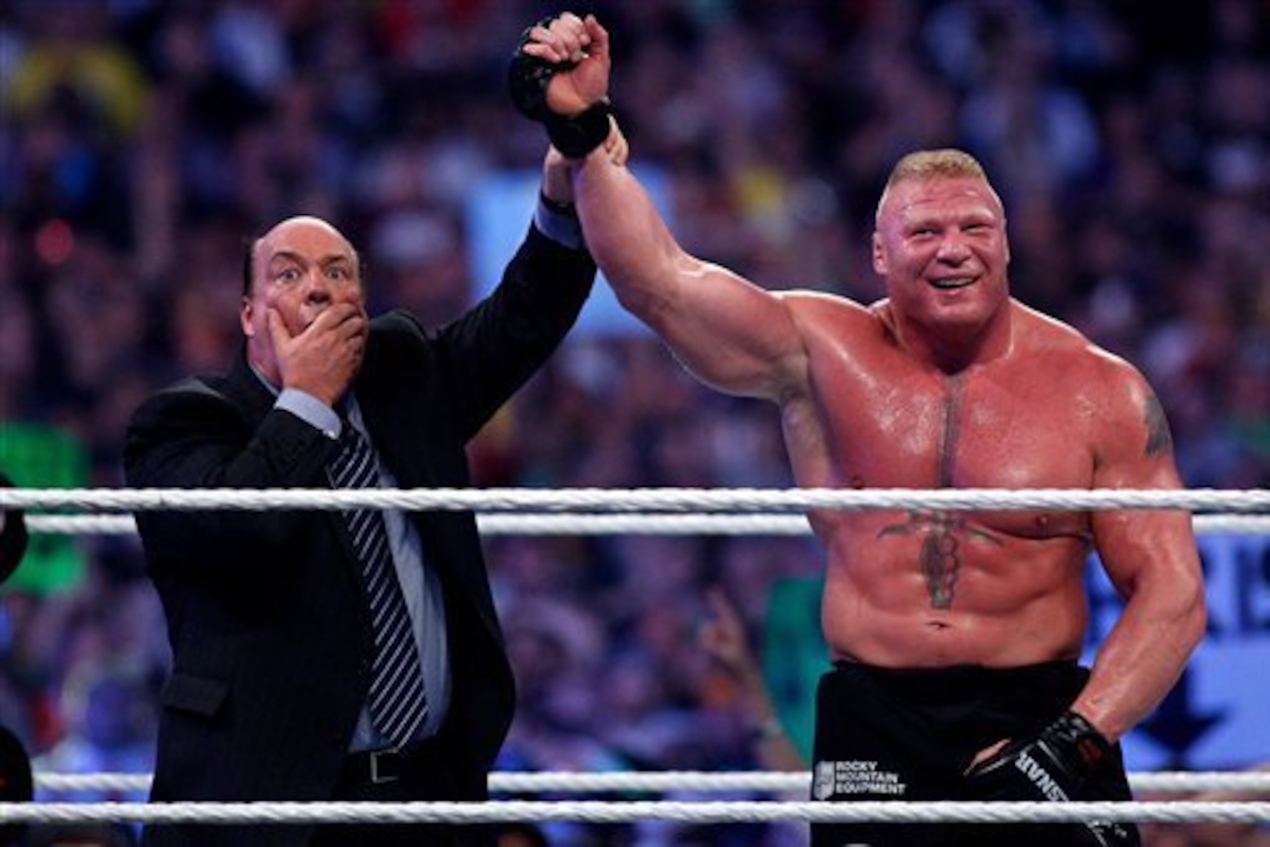 Paul Heyman and Brock Lesnar celebrate a victory over Undertaker.