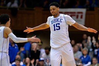 DURHAM, NC - FEBRUARY 04:  Jahlil Okafor #15 high-fives teammate Tyus Jones #5 of the Duke Blue Devils during a win against the Georgia Tech Yellow Jackets at Cameron Indoor Stadium on February 4, 2015 in Durham, North Carolina. Duke won 72-66.  (Photo by