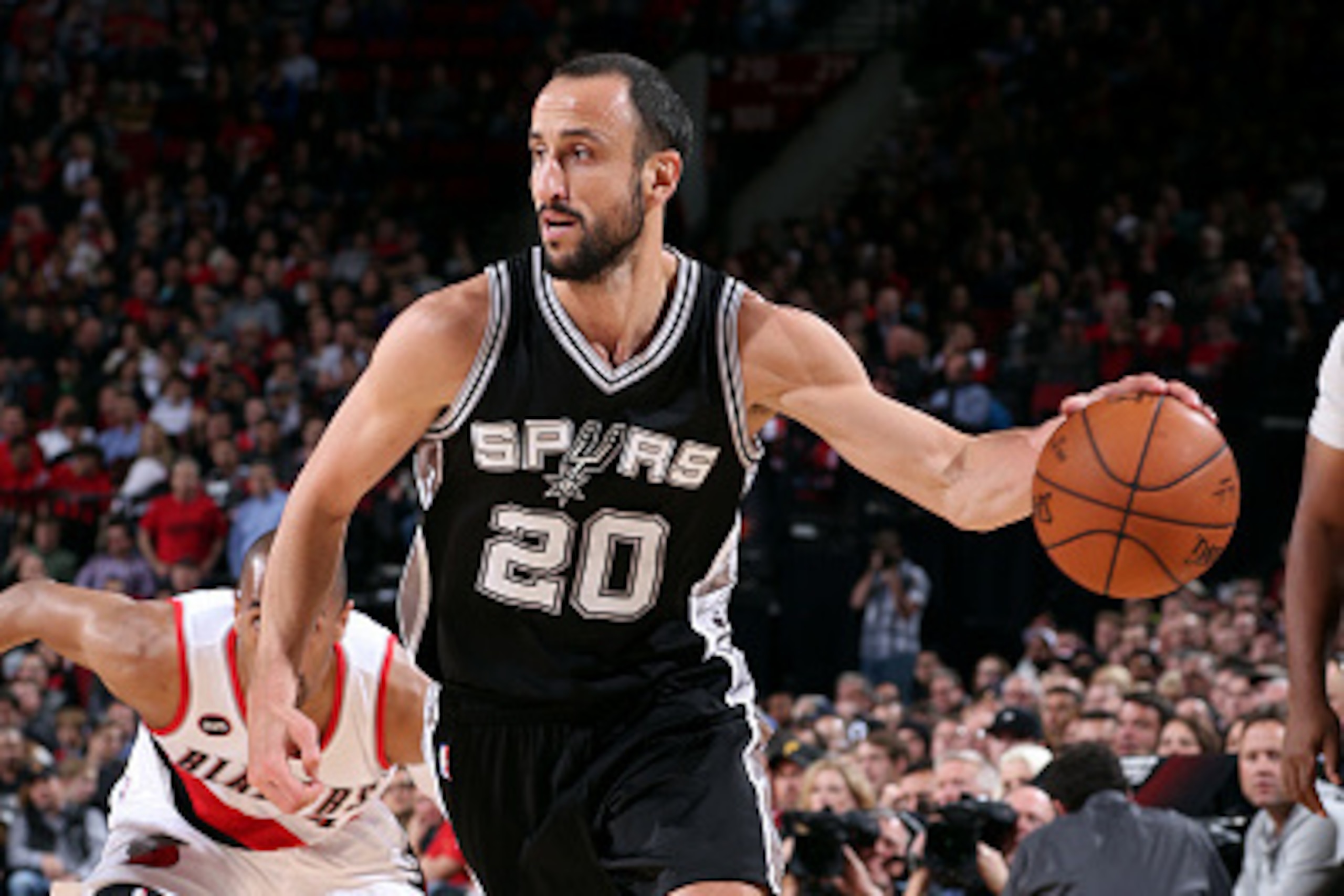PORTLAND, OR - FEBRUARY 25: Manu Ginobili #20 of the San Antonio Spurs drives against the Portland Trail Blazers on February 25, 2015 at the Moda Center in Portland, Oregon. NOTE TO USER: User expressly acknowledges and agrees that, by downloading and or 