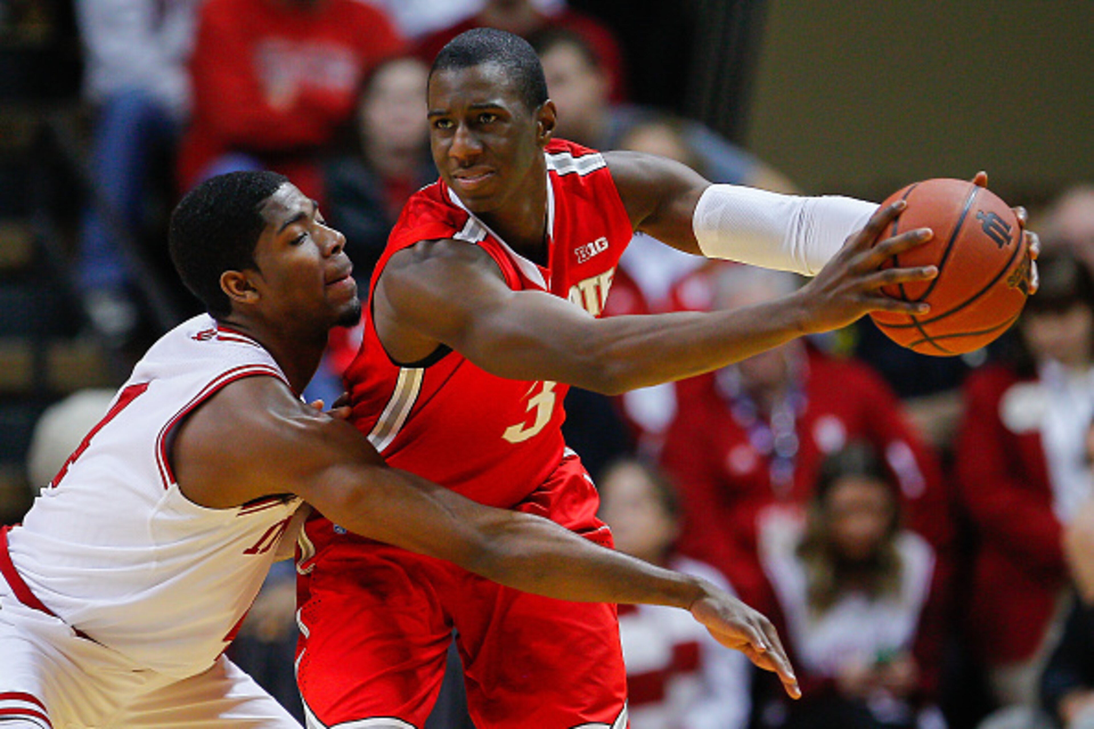 BLOOMINGTON, IN - JANUARY 10: Robert Johnson #4 of the Indiana Hoosiers reaches in as Shannon Scott #3 of the Ohio State Buckeyes holds the ball at Assembly Hall on January 10, 2015 in Bloomington, Indiana. Indiana defeated Ohio State 69-66. (Photo by Mic