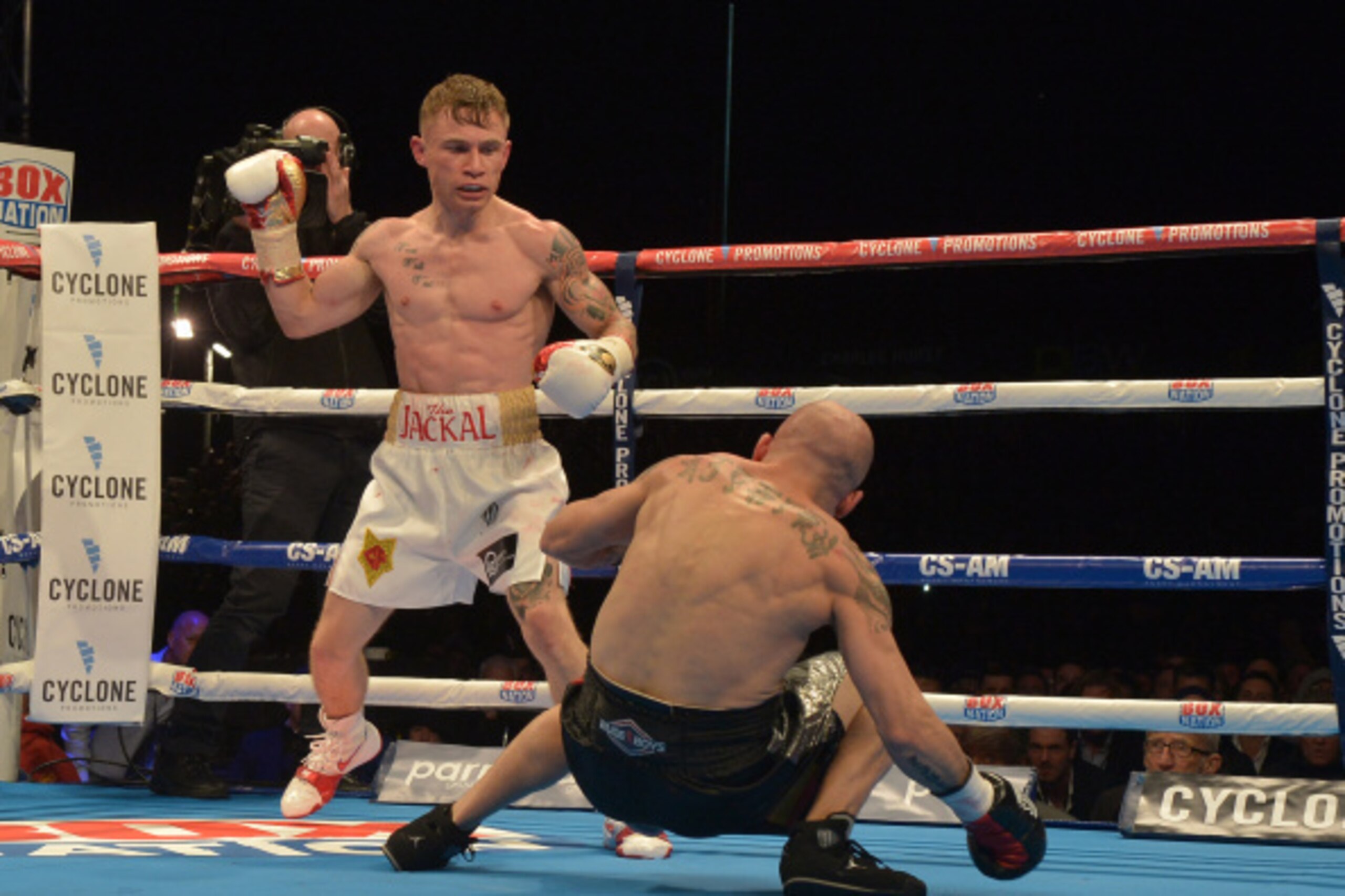 BELFAST, NORTHERN IRELAND - SEPTEMBER 6: Carl Frampton of Northern Ireland knocks down Kiko Martinez of Spain during their IBF super-bantamweight world title bout, at the purpose-built 16,000 capacity Titanic slipway outdoor arena on September 6, 2014 in 