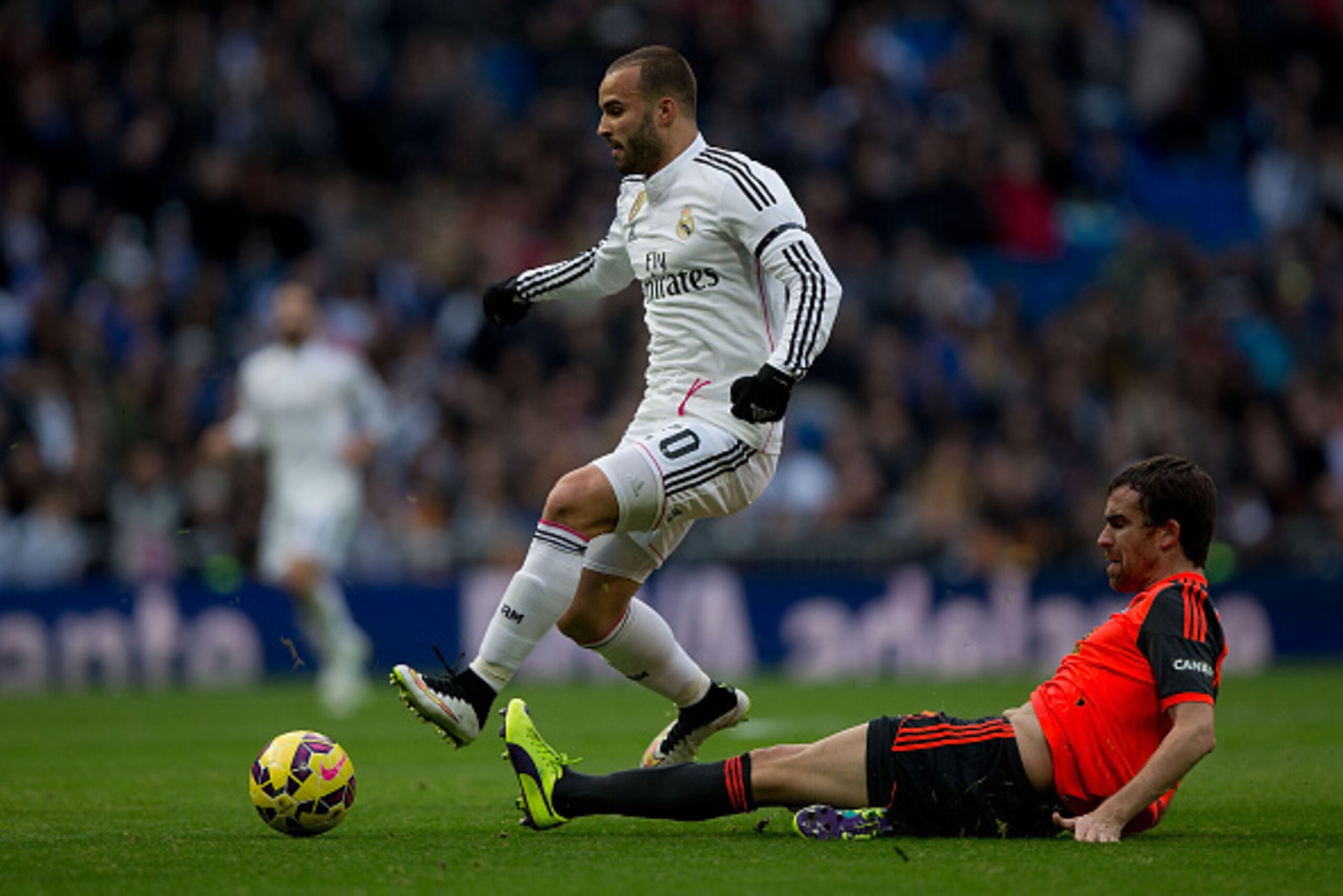 MADRID, SPAIN - JANUARY 31: Jese Rodriguez (L) of Real Madrid CF competes for the ball with Mikel Gonzalez (R) Real Sociedad de Futbol during the La Liga match between Real Madrid CF and Real Sociedad de Futbol at Estadio Santiago Bernabeu on January 31, 