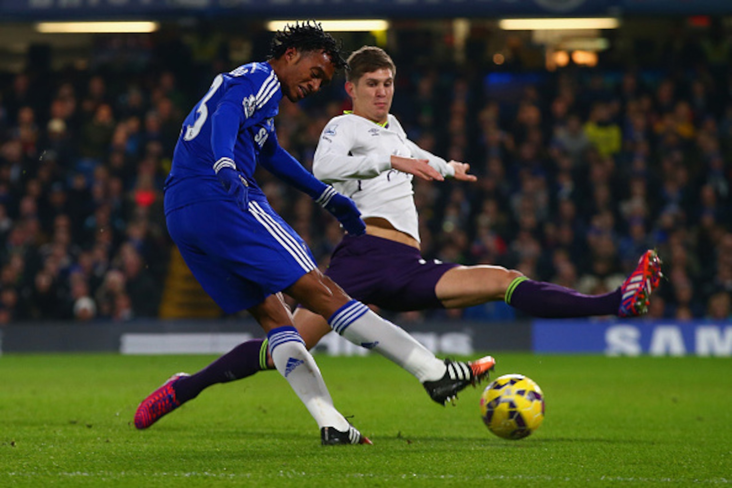 LONDON, ENGLAND - FEBRUARY 11:  John Stones of Everton attempts to block an effort from Juan Cuadrado of Chelsea during the Barclays Premier League match between Chelsea and Everton at Stamford Bridge on February 11, 2015 in London, England.  (Photo by Cl