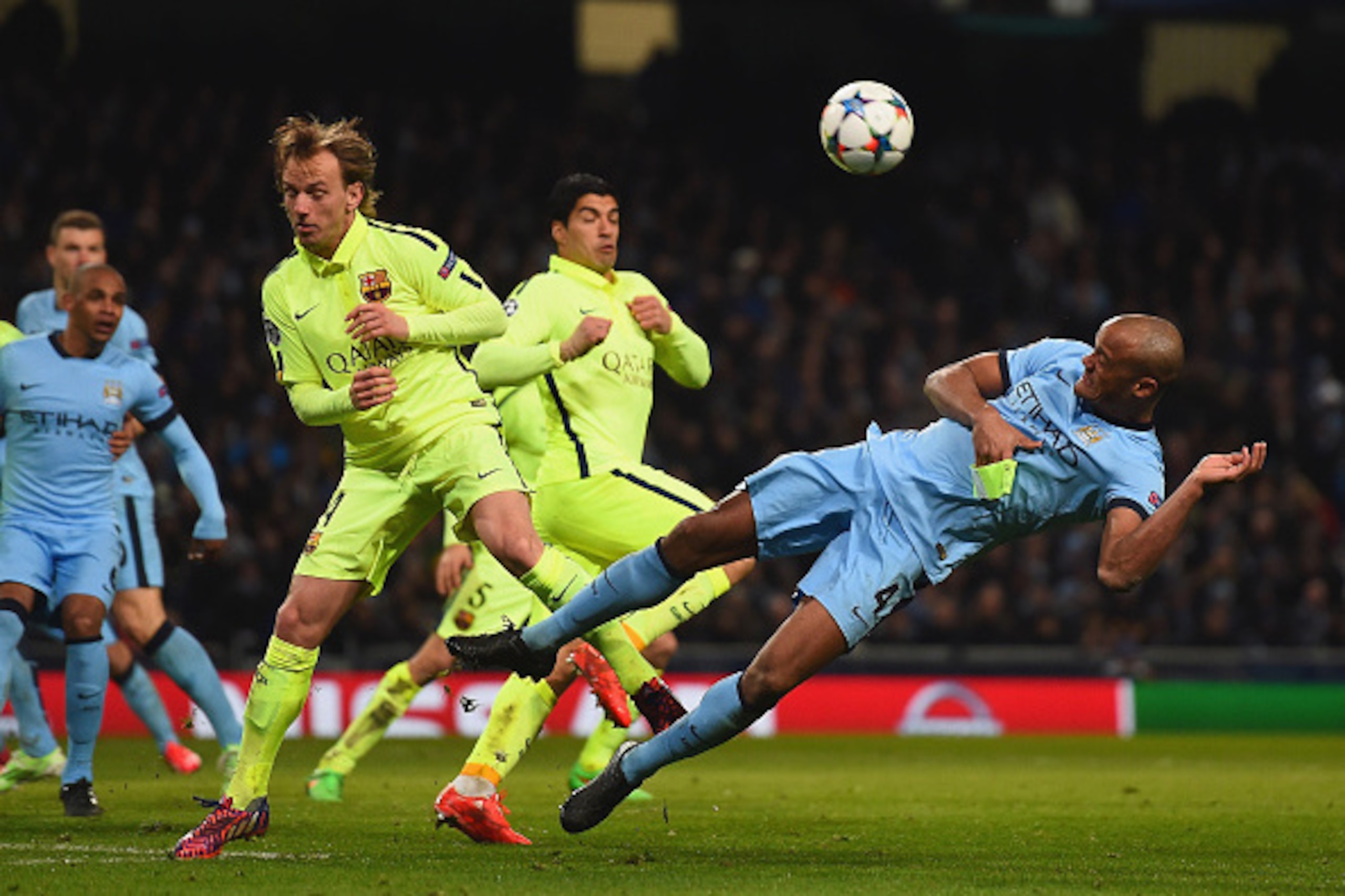 MANCHESTER, ENGLAND - FEBRUARY 24: Ivan Rakitic of Barcelona and Vincent Kompany of Manchester City batlte for the ball during the UEFA Champions League Round of 16 match between Manchester City and Barcelona at Etihad Stadium on February 24, 2015 in Manc MANCHESTER, ENGLAND - FEBRUARY 24: Ivan Rakitic of Barcelona and Vincent Kompany of Manchester City batlte for the ball during the UEFA Champions League Round of 16 match between Manchester City and Barcelona at Etihad Stadium on February 24, 2015 in Manc