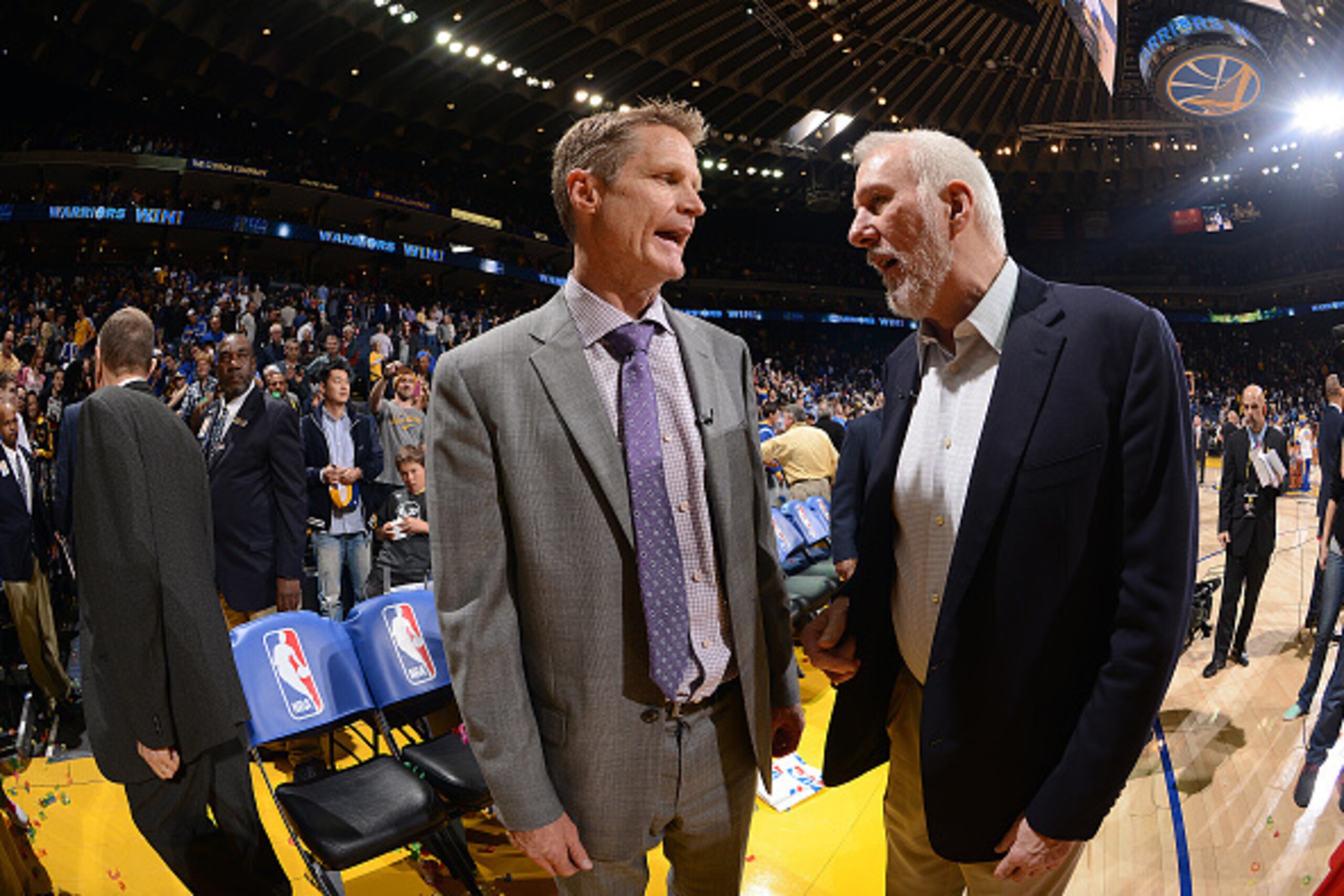 OAKLAND, CA - FEBRUARY 20: Head Coach Steve Kerr of the Golden State Warriors speaks with Head Coach Gregg Popovich of the San Antonio Spurs after the game on February 20, 2015 at Oracle Arena in Oakland, California. NOTE TO USER: User expressly acknowled