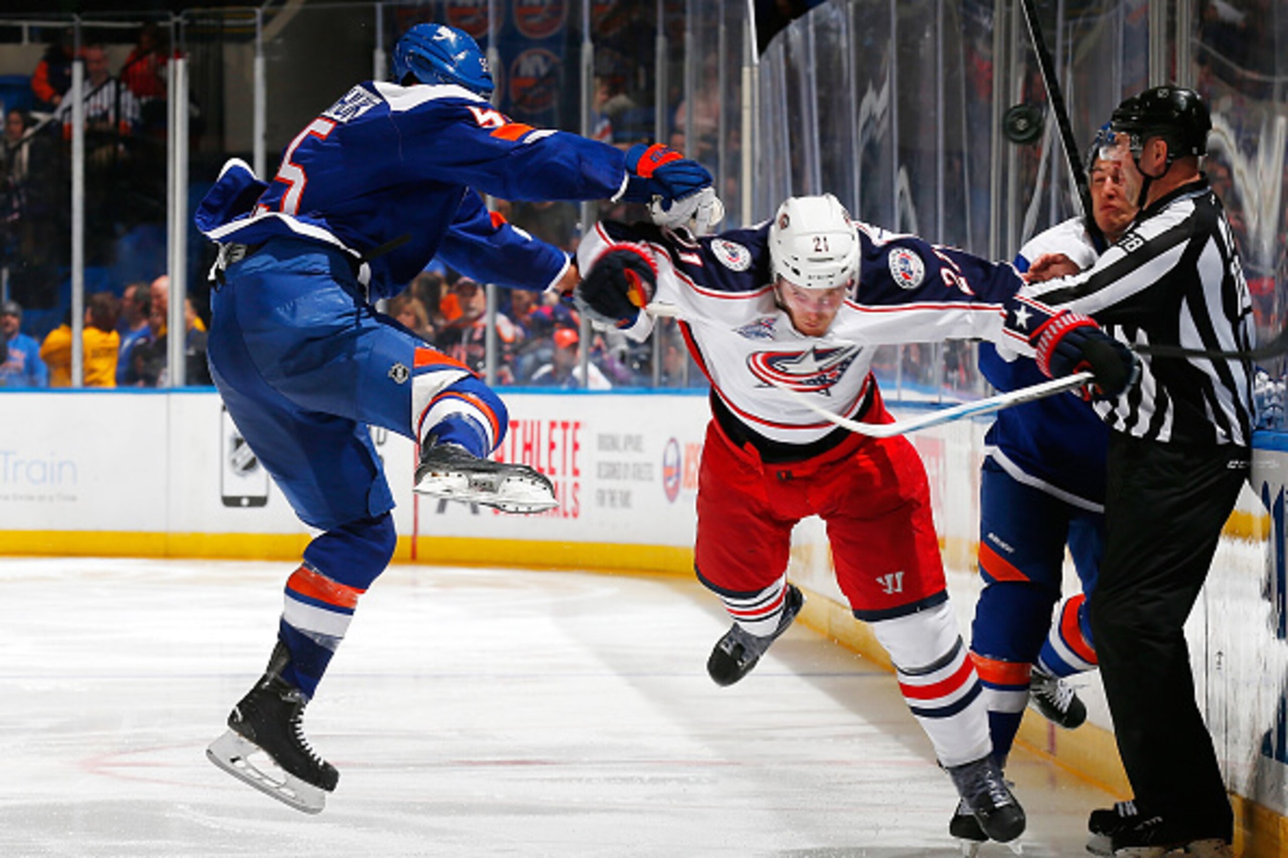 UNIONDALE, NY - FEBRUARY 14: James Wisniewski #21 of the Columbus Blue Jackets and Johnny Boychuk #55 of the New York Islanders battle for the puck at Nassau Veterans Memorial Coliseum on February 14, 2015 in Uniondale, New York. The New York Islanders de
