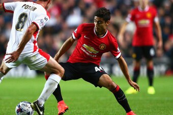 MILTON KEYNES, ENGLAND - AUGUST 26: Andreas Pereira of Manchester United takes on Darren Potter of Milton Keynes Dons during the Capital One Cup Second Round match between MK Dons and Manchester United at Stadium mk on August 26, 2014 in Milton Keynes, En