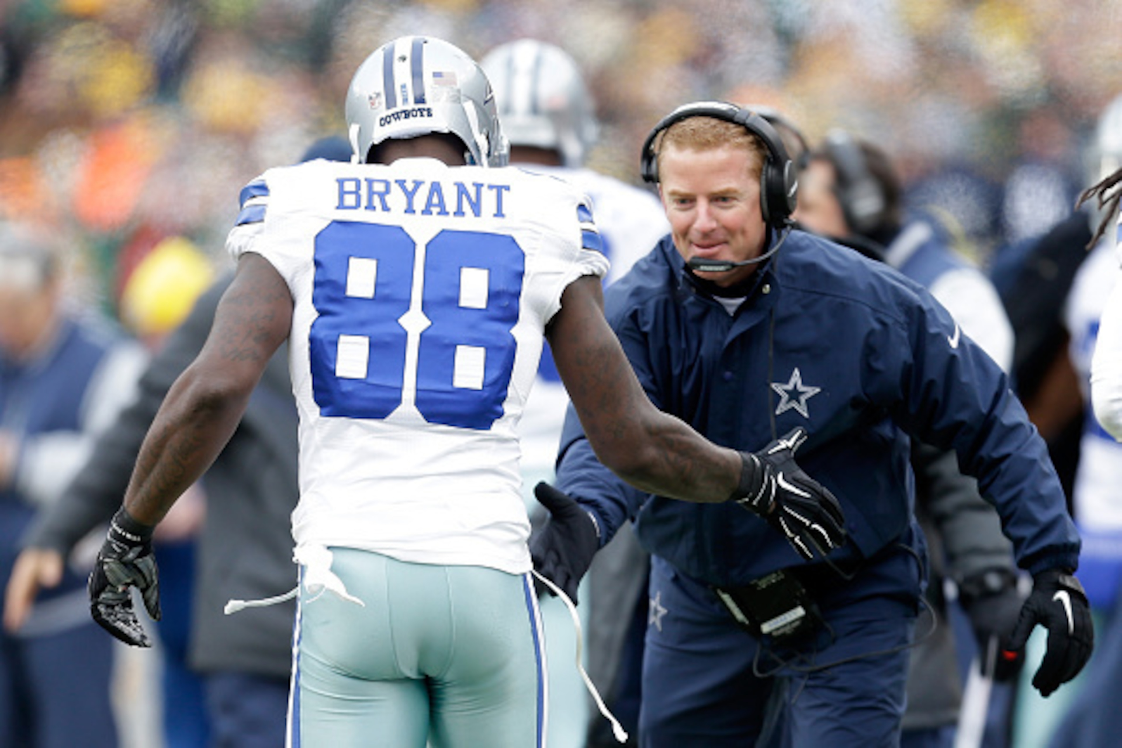 GREEN BAY, WI - JANUARY 11: Head coach Jason Garrett celebrates with Dez Bryant #88 of the Dallas Cowboys after a touchdown against the Green Bay Packers to the 2015 NFC Divisional Playoff game against the Green Bay Packers at Lambeau Field on January GREEN BAY, WI - JANUARY 11: Head coach Jason Garrett celebrates with Dez Bryant #88 of the Dallas Cowboys after a touchdown against the Green Bay Packers to the 2015 NFC Divisional Playoff game against the Green Bay Packers at Lambeau Field on January