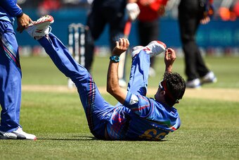 DUNEDIN, NEW ZEALAND - FEBRUARY 26: Hamid Hassan of Afghanistan celebrates holding a catch during the 2015 ICC Cricket World Cup match between Afghanistan and Scotland at University Oval on February 26, 2015 in Dunedin, New Zealand.  (Photo by Martin Hunt