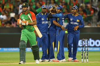 MELBOURNE, AUSTRALIA - FEBRUARY 26:  Lasith Malinga of Sri Lanka is congratulated by team mates after getting the wicket of Taskin Ahmed of Bangladesh during the 2015 ICC Cricket World Cup match between Sri Lanka and Bangladesh at Melbourne Cricket Ground
