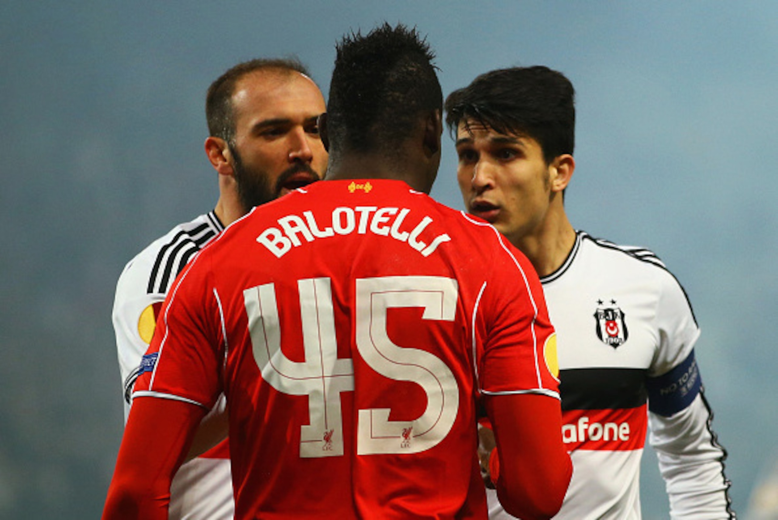 ISTANBUL, TURKEY - FEBRUARY 26: Mario Balotelli of Liverpool clashes with Necip Uysal (R) and Serdar Kurtulus of Besiktas during the UEFA Europa League Round of 32 second leg match between Besiktas JK and Liverpool FC on February 26, 2015 in Istanbul, Tu ISTANBUL, TURKEY - FEBRUARY 26: Mario Balotelli of Liverpool clashes with Necip Uysal (R) and Serdar Kurtulus of Besiktas during the UEFA Europa League Round of 32 second leg match between Besiktas JK and Liverpool FC on February 26, 2015 in Istanbul, Tu