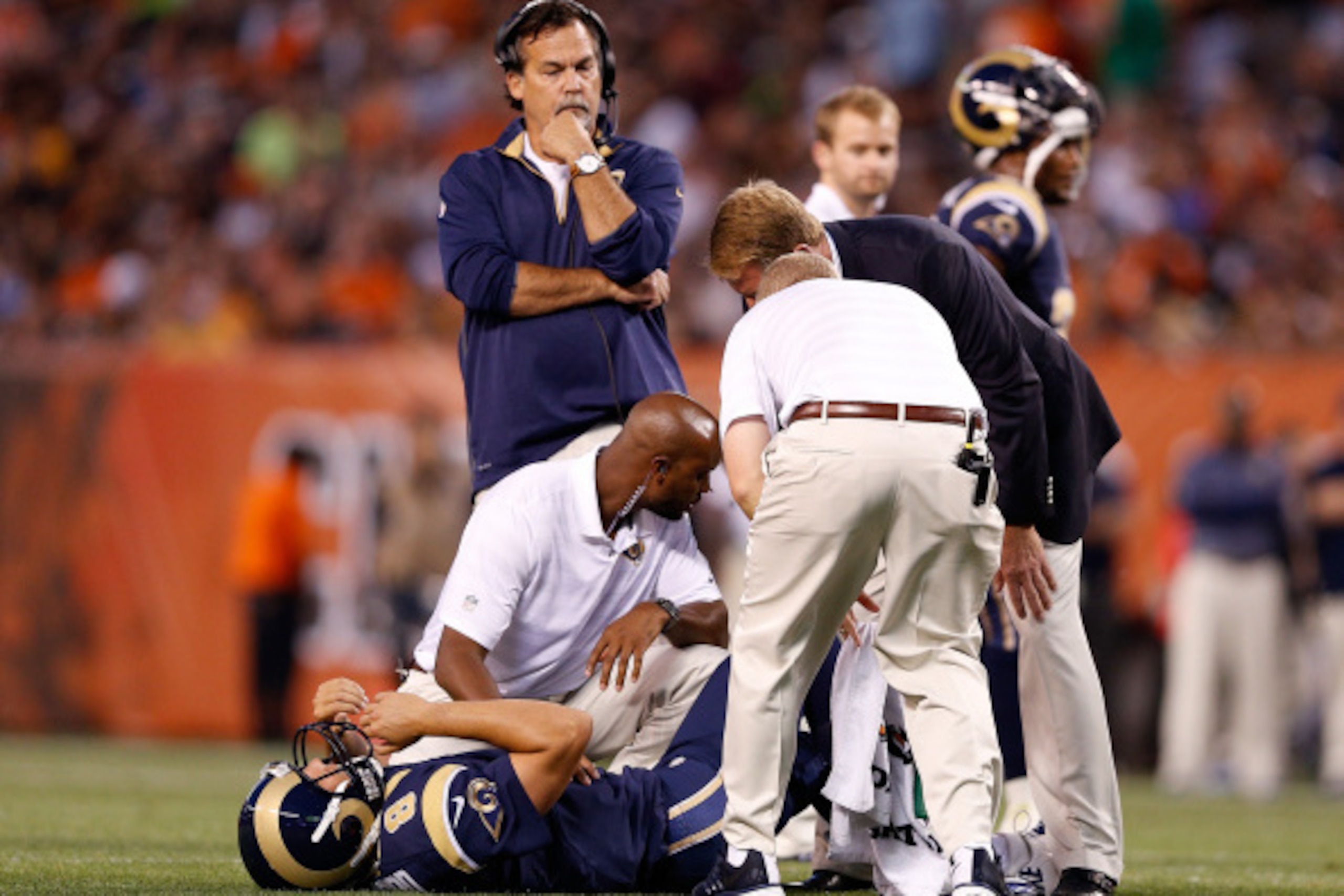 CLEVELAND, OH - AUGUST 23:  Sam Bradford #8 of the St. Louis Rams is looked at by trainers after being injured in the first quarter of the preseason game against the Cleveland Browns at FirstEnergy Stadium on August 23, 2014 in Cleveland, Ohio.  (Photo by
