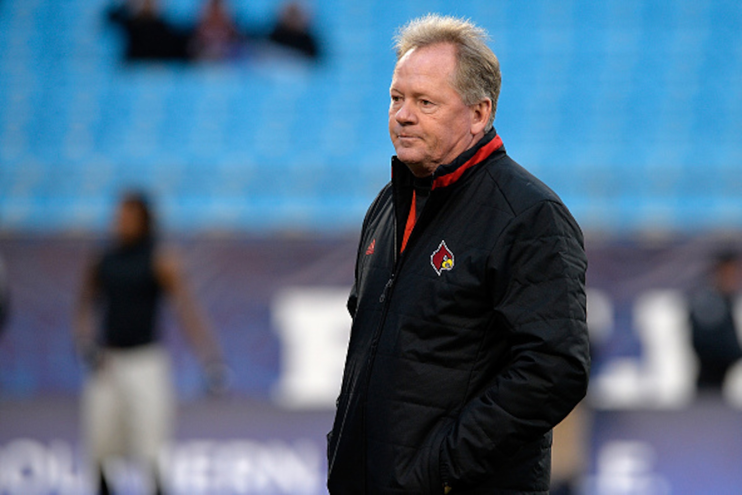 CHARLOTTE, NC - DECEMBER 30:  Head coach Bobby Petrino of the Louisville Cardinals watches his team warm up before a game against the Georgia Bulldogs at the Belk Bowl at Bank of America Stadium on December 30, 2014 in Charlotte, North Carolina.  (Photo b